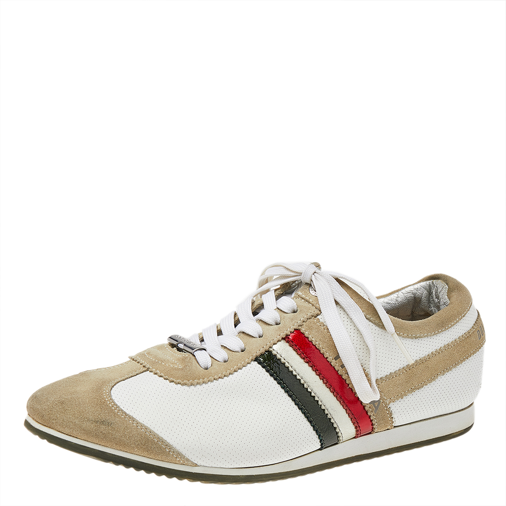 These low top sneakers by Dolce and Gabbana have been crafted from suede and leather. They come in beige and white hues with lace up fronts and feature the brand label on the counters and stripe detailing on the sides. They are designed to deliver style and comfort and make for a great buy.