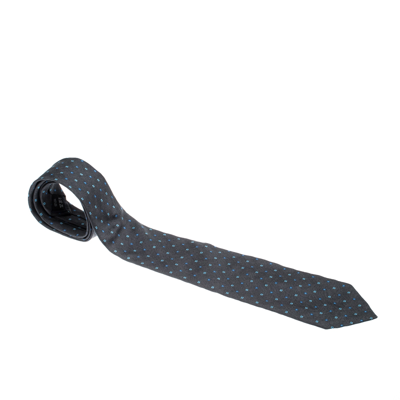 Cut from quality silk this charcoal grey Dunhill tie features square patterns in jacquard all over. The piece is complete with the brand label on the keeper loop at the back. Look smart by pairing it with plain shirts.