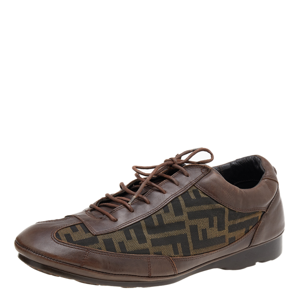 Equipped with a signature appeal and classic style these Fendi low top sneakers are absolute stunners. Crafted from Zucca canvas and leather they come in a lovely shade of brown. They are styled with lace up vamps logo detail on the counters and rubber soles.