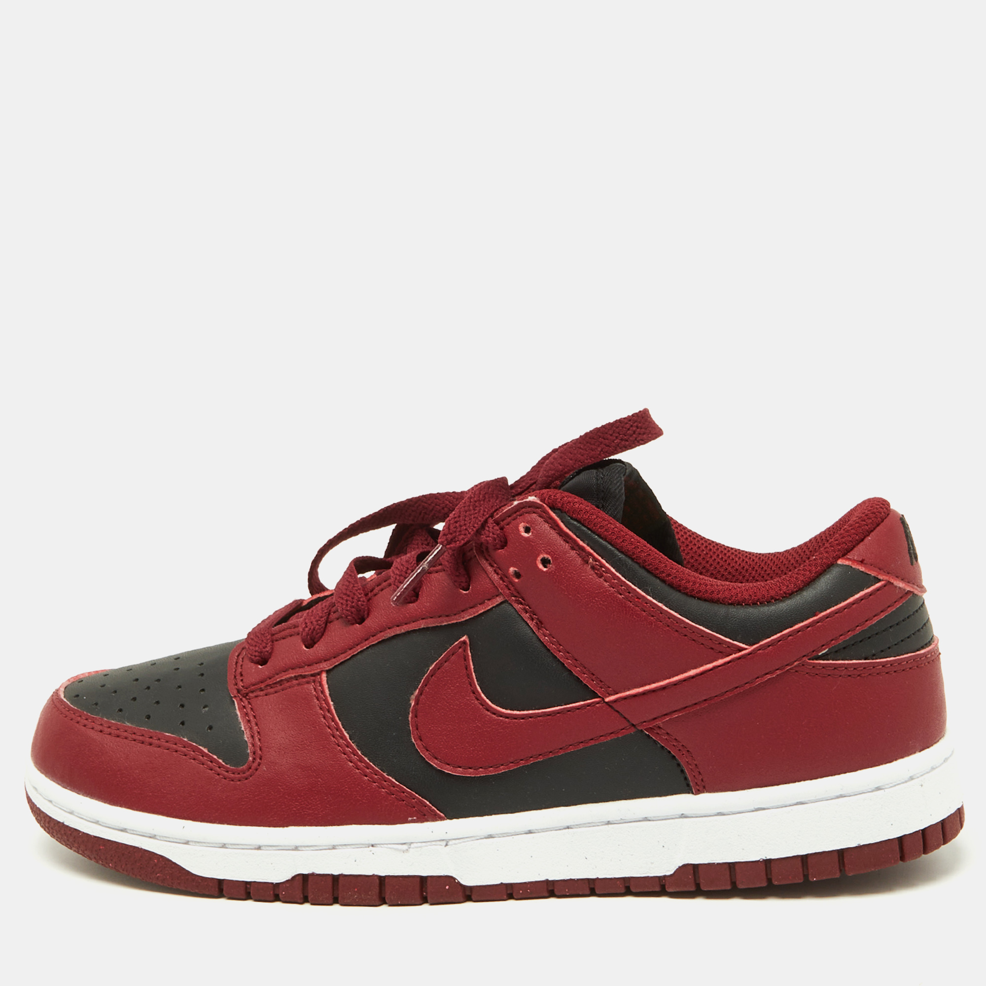 The Nike Dunk low top Team Red sneakers are a striking fusion of style and sportiness. Crafted with premium leather the bold red and black colorway exudes confidence and sophistication. The iconic Dunk silhouette ensures timeless appeal while the low top design offers comfort and versatility for everyday wear.