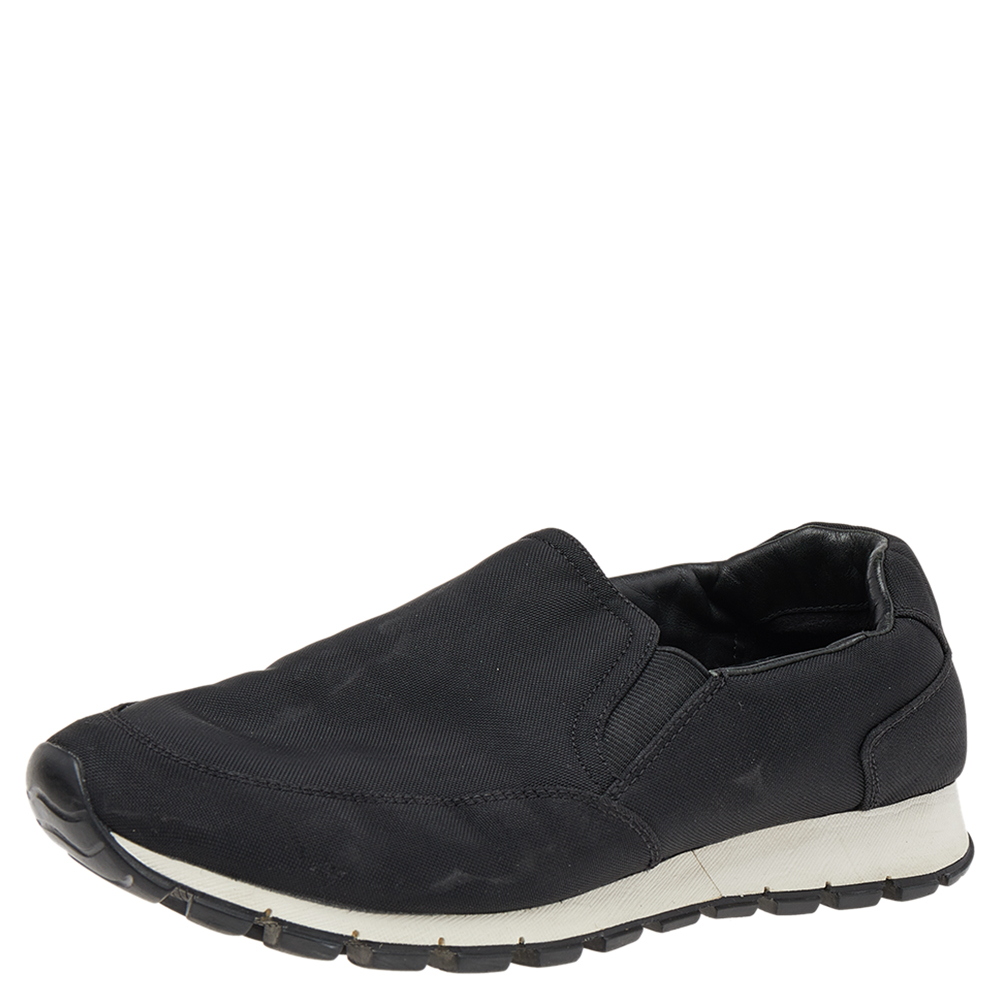 These comfortable and snug Prada Sport slip ons are an essential. These black sneakers are made from nylon featuring padded ankles and stretch inserts for easy fit. They are lined with black leather and finished with rubber soles.