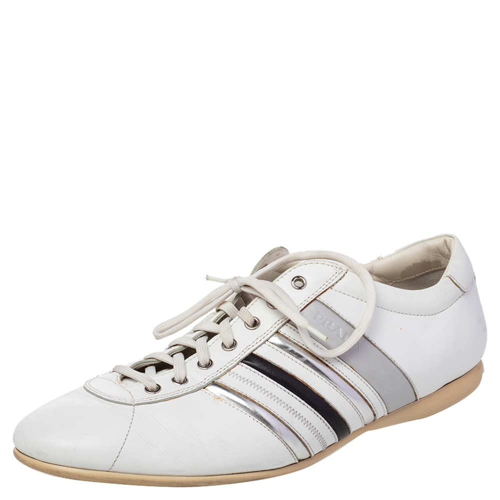 Meticulously crafted using only the finest materials Prada shoes are recognized for their top quality design. Clean cut and built for comfort this pair of white Prada sneakers are trendy and comfy. They have been crafted from leather and feature a lace up vamp and stripe detailing on the sides. Wear them over your casual outfits and look effortlessly neat.