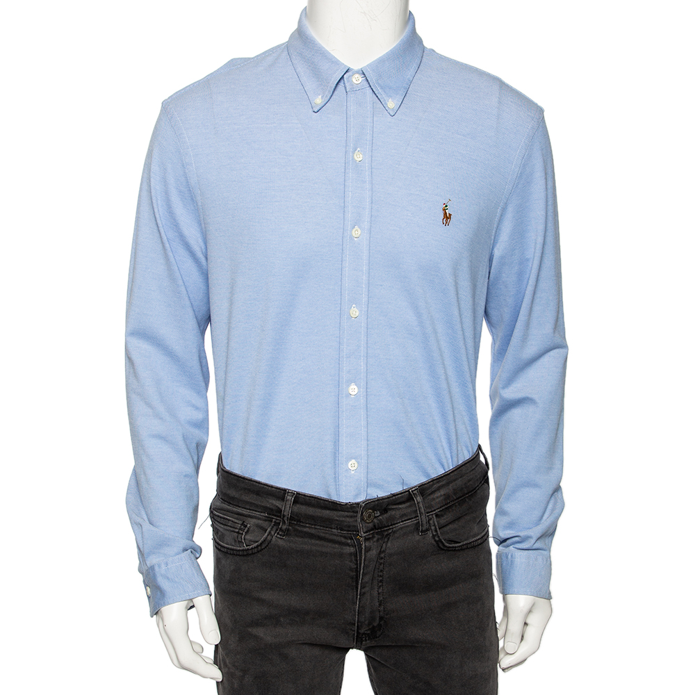 How stylish is this Oxford shirt from Ralph Lauren It is made using blue cotton and flaunts an embroidered logo detail on the front. It has a button front feature long sleeves and buttoned cuffs. Match this shirt with pants and look polished.