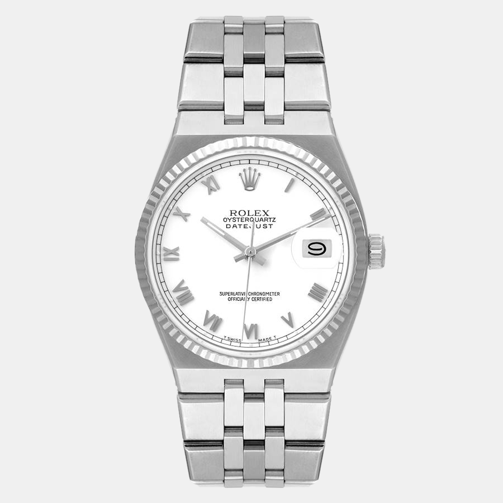 Looking for the perfect accessory to lend an elegant edge to your outfits? Go for this stylish Rolex Datejust wristwatch. The watch boasts a white dial featuring raised Roman numeral hour markers and a date window with a stainless steel oyster case and an 18k white gold fluted bezel. It is secured by a stainless steel oyster quartz bracelet.