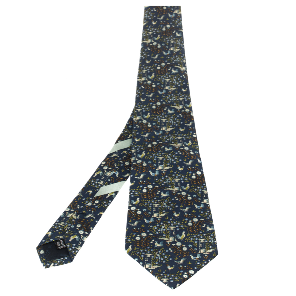 Experiment with pattern by choosing this tie from Salvatore Ferragamo. This navy blue tie features a fun well print throughout and can be worn with a day shirt for a distinguished fashion statement.