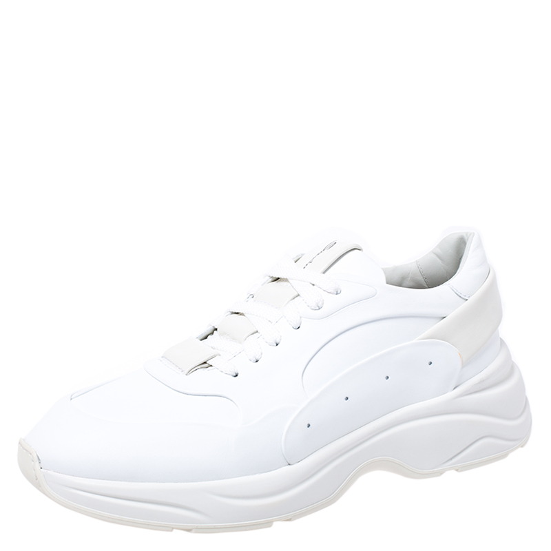 Made from high quality leather these sneakers look perfect when paired with any outfit of your choice. Make a bold statement as you flaunt your style with these chunky rubber soled sneakers. Santoni brings you this impressive pair that resounds well with the on going sneaker trend. You need to add these versatile white sneakers to your collection now.