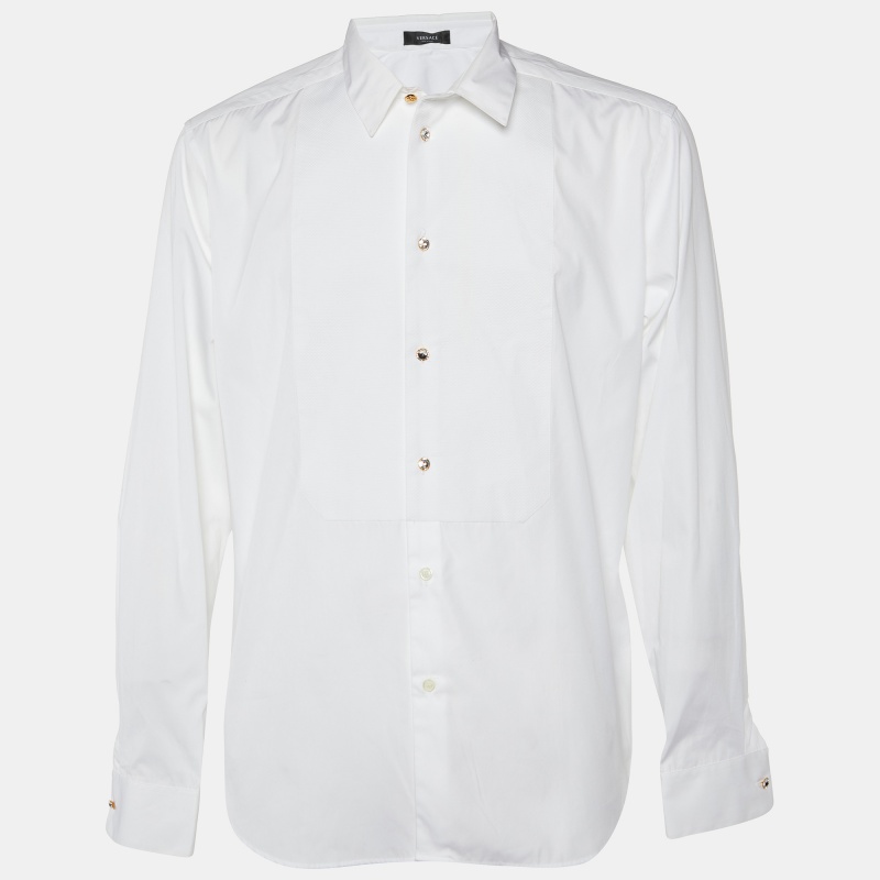 Elevate your wardrobe with the exquisite Versace shirt. Impeccably crafted from premium cotton this shirt exudes sophistication and refinement. The intricate crystal buttons detailing adds a touch of opulence ensuring you stand out with understated glamour and timeless elegance.