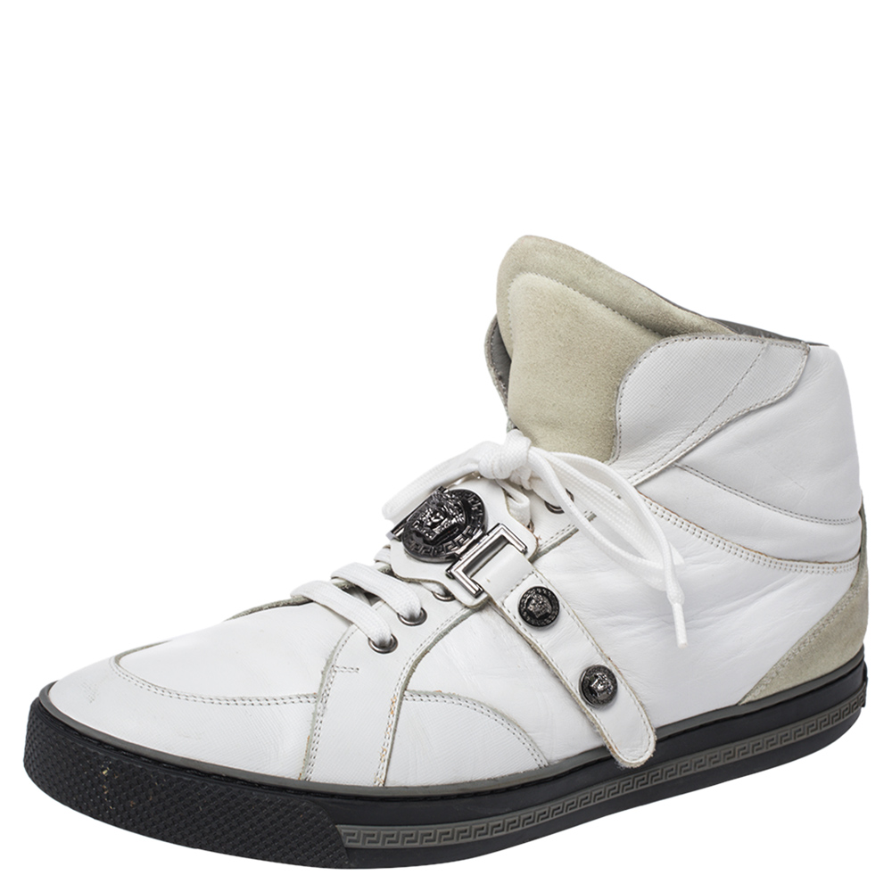 Brimming with fabulous details these Versace sneakers are crafted from leather into a high top silhouette and feature lace up vamps gunmetal tone studs and the iconic Medusa logo. Comfortable soles and trendy appeal make these sneakers a must buy.