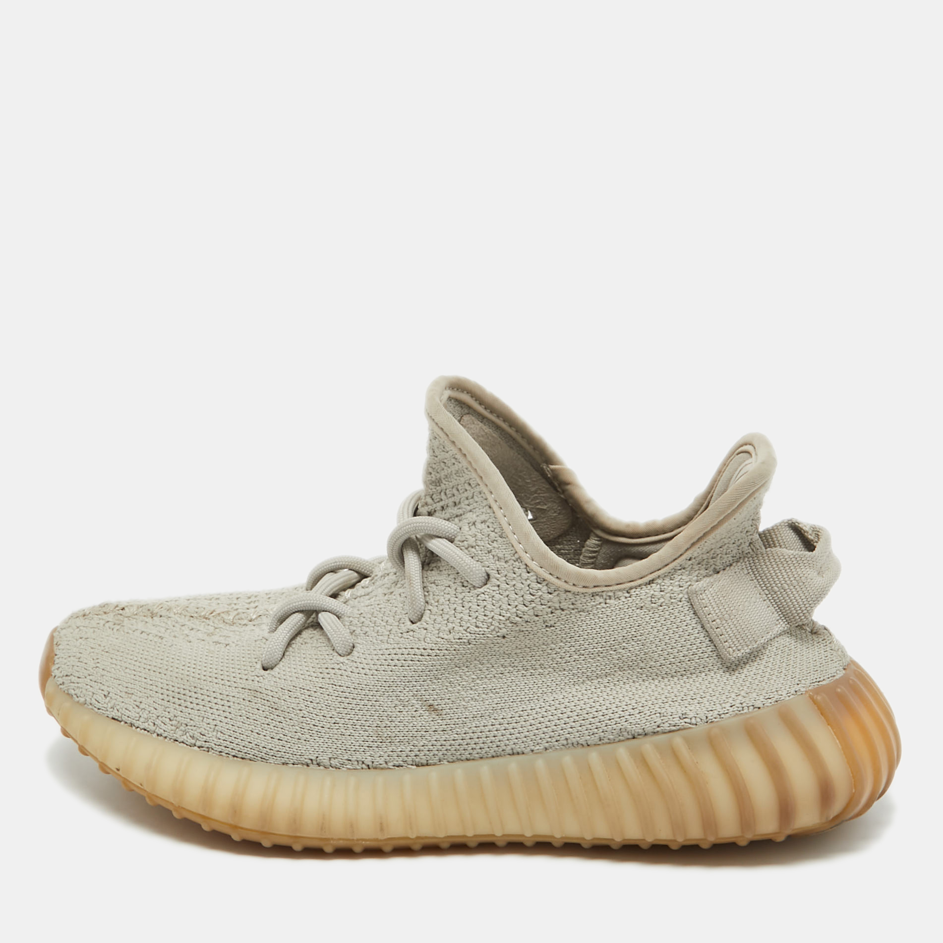 Introducing the Yeezy x adidas Boost 350 V2 Sesame sneakers where style meets comfort effortlessly. Crafted with precision the sleek grey knit fabric seamlessly merges with Boost technology ensuring unparalleled cushioning. These kicks elevate any ensemble embodying the epitome of contemporary urban fashion.