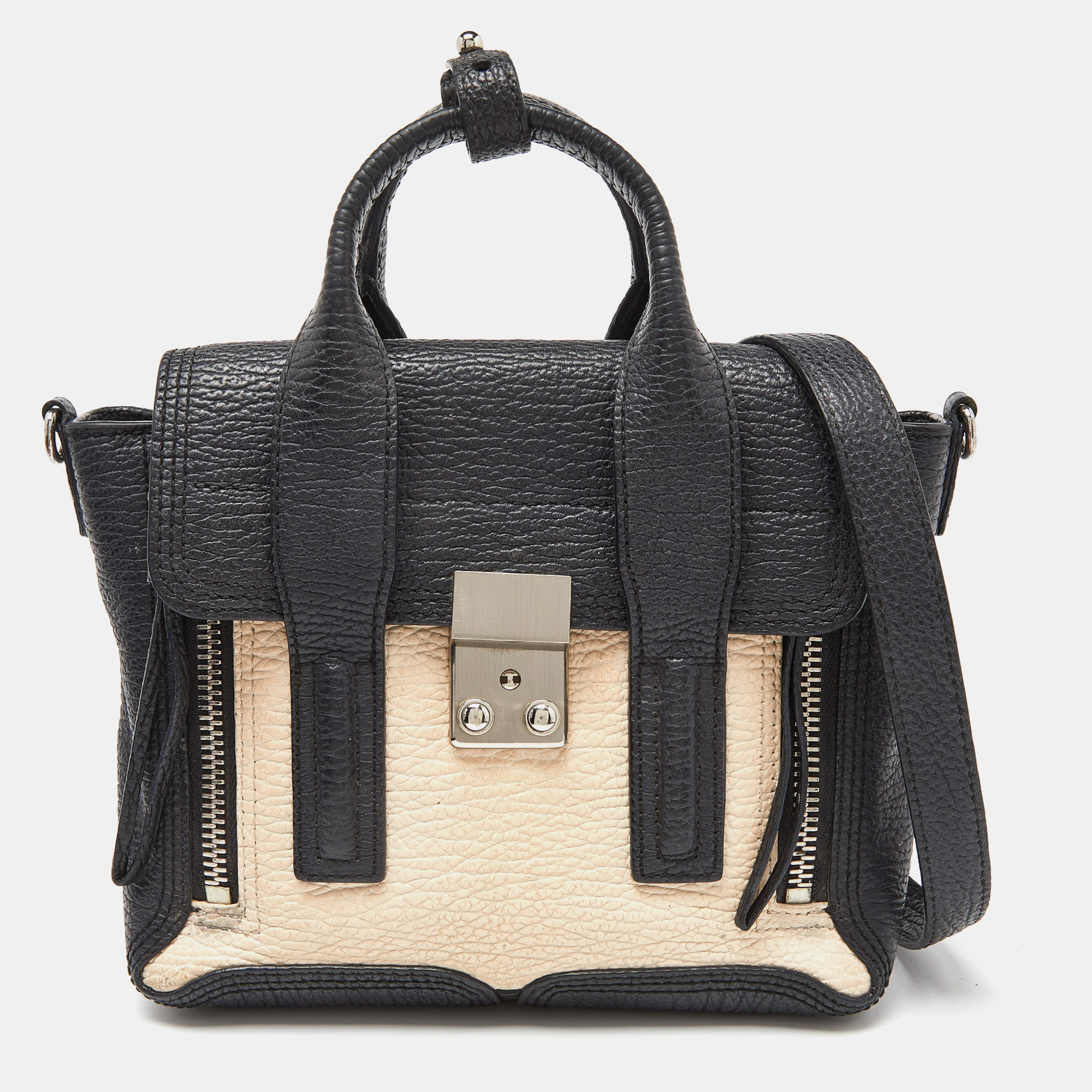 The structured shape and functional characteristics make this satchel by 3.1 Phillip Lim a thoughtful investment. Lined with fabric your valuables are secured with a lock closure on the front flap. The zipper pockets at the front and the dual carrying options make this bag a reliable accessory.