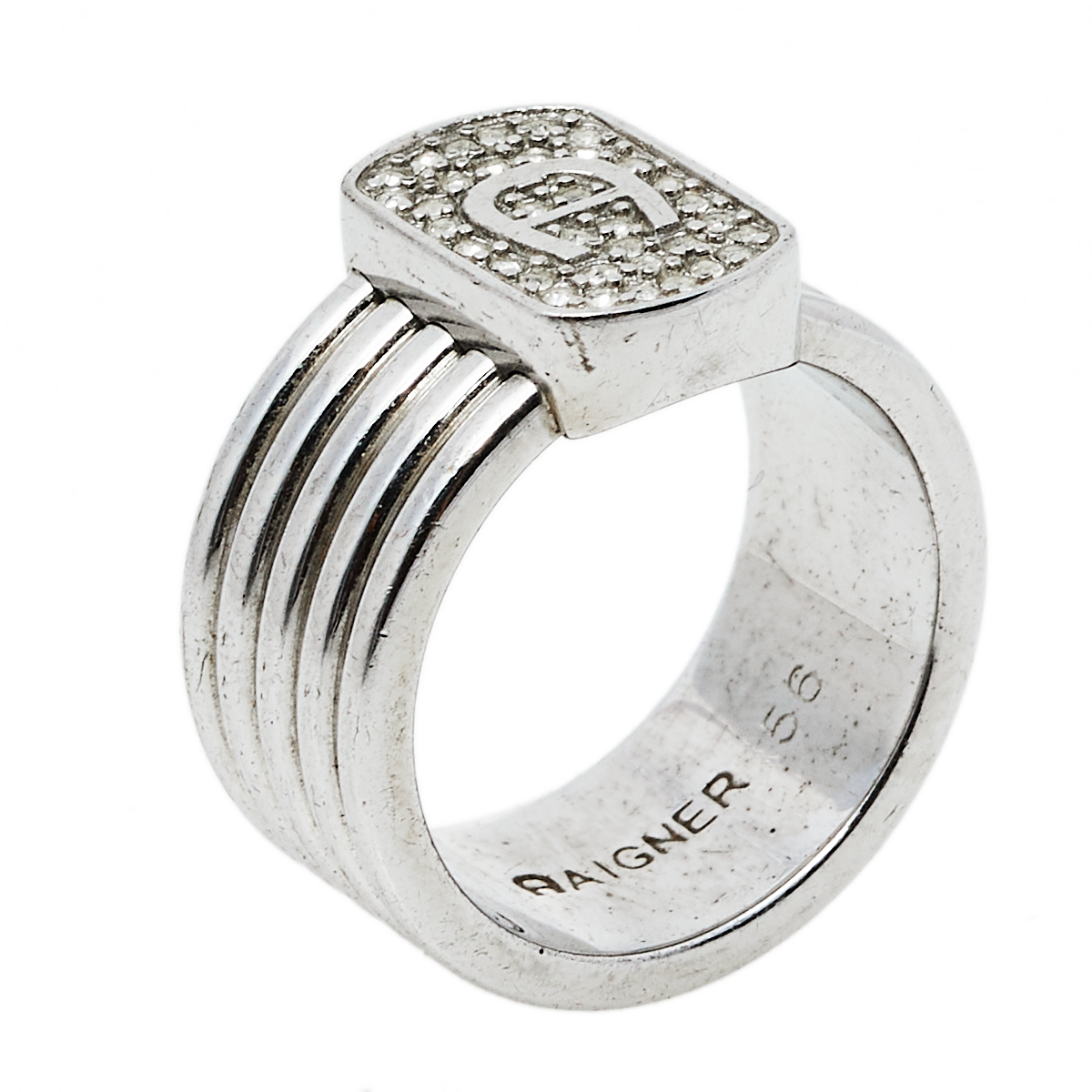 Add a statement finish to your look of the day with this Aigner ring. Featuring a silver tone band this ring is topped with a crystal embedded logo top. Wear it stacked with other rings or as a stand alone piece.
