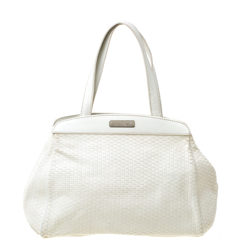 This stunning satchel is by Aigner. Crafted from off white leather the bag features weave patterns two handles and a spacious fabric interior. Place it in your arms to lend your outfit the appropriate measure of class and style.