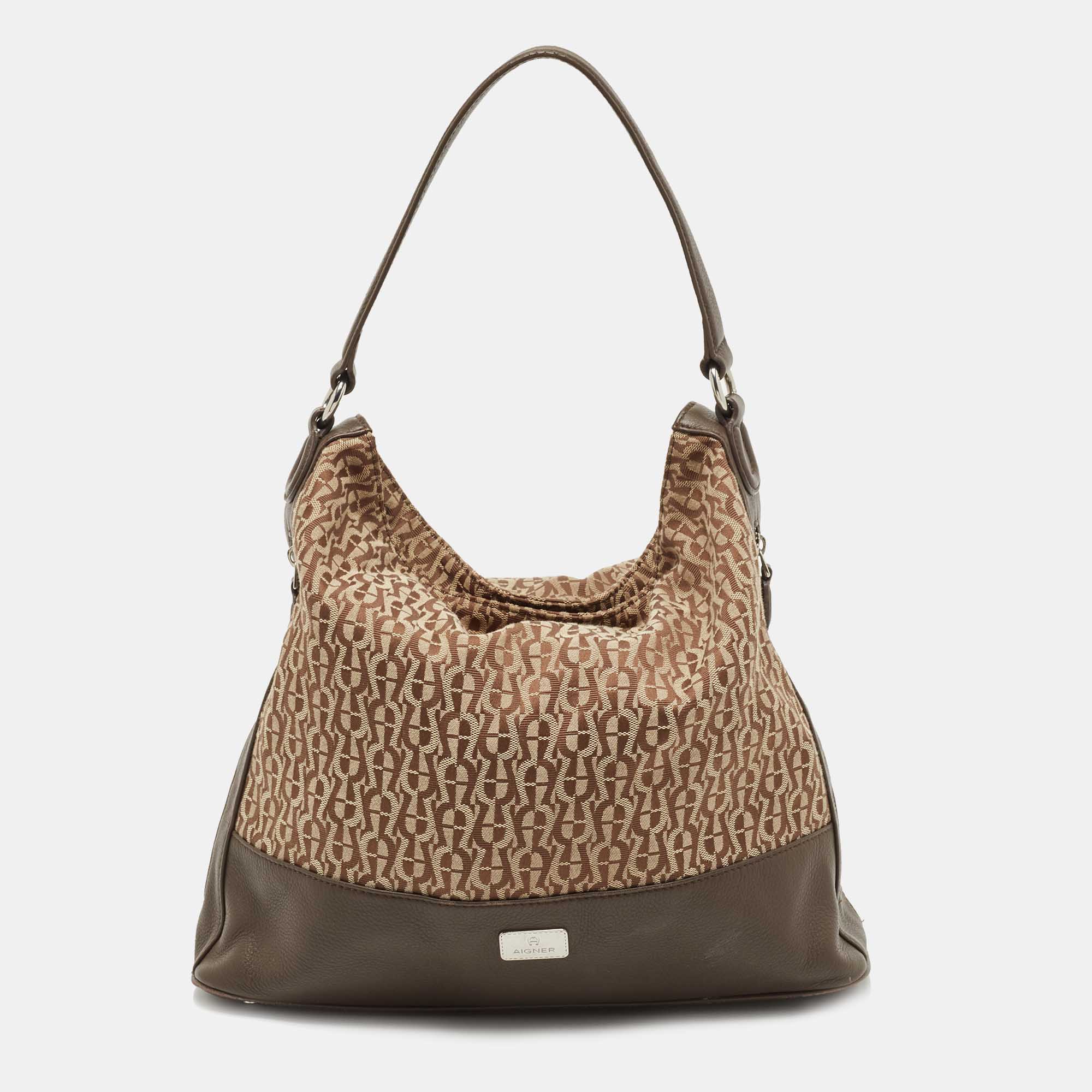 Elevate your day to day look by carrying this sleek Aigner hobo from work to weekend. This bag features a quality fabric lined interior. This bag is made of monogram canvas and leather. Elegance meets style effortlessly when you team up your outfit with this hobo.