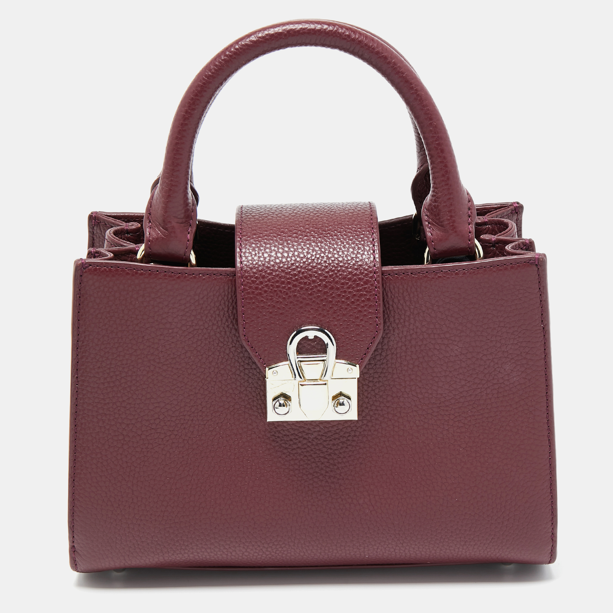 This elegant tote is perfect for your next outing to town. It is made of high quality leather and can match a day or evening outfit. It has two handles and a shiny metal clasp.