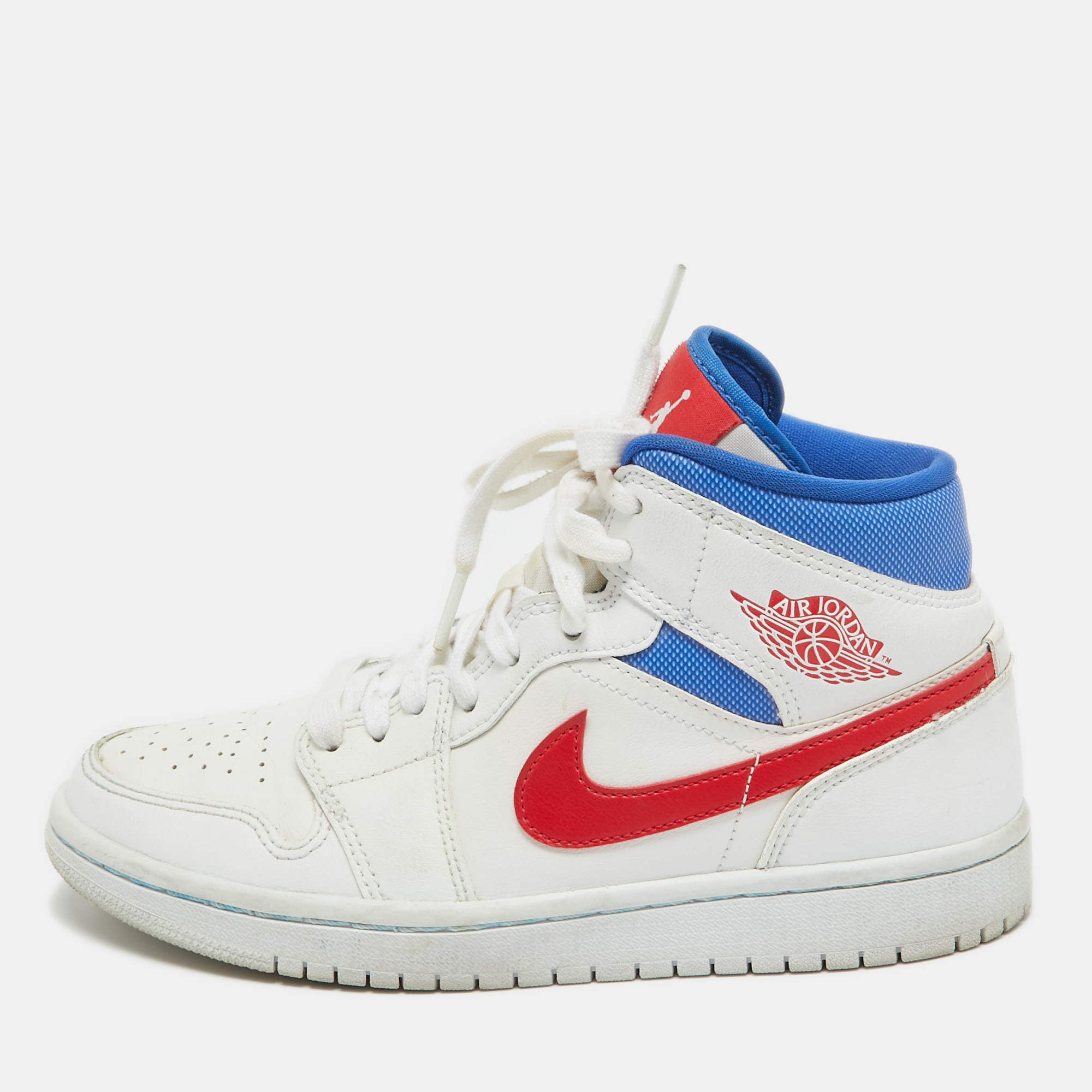 The Air Jordan 1 Mid sneakers exude timeless charm with their pristine white base accented by bold splashes of blue and red. Crafted from premium leather they boast durability and style. Whether on the court or the streets these sneakers make a statement of classic athleticism and flair.