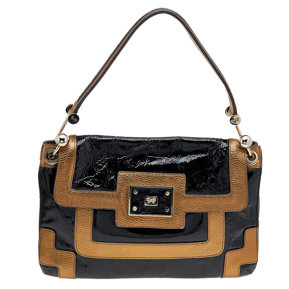 Elevate your style with this gorgeous shoulder bag by Anya Hindmarch. Crafted from black patent leather and gold leather the bag features gold tone hardware the logo on the flap and a well sized suede interior. It is complete with a single handle.