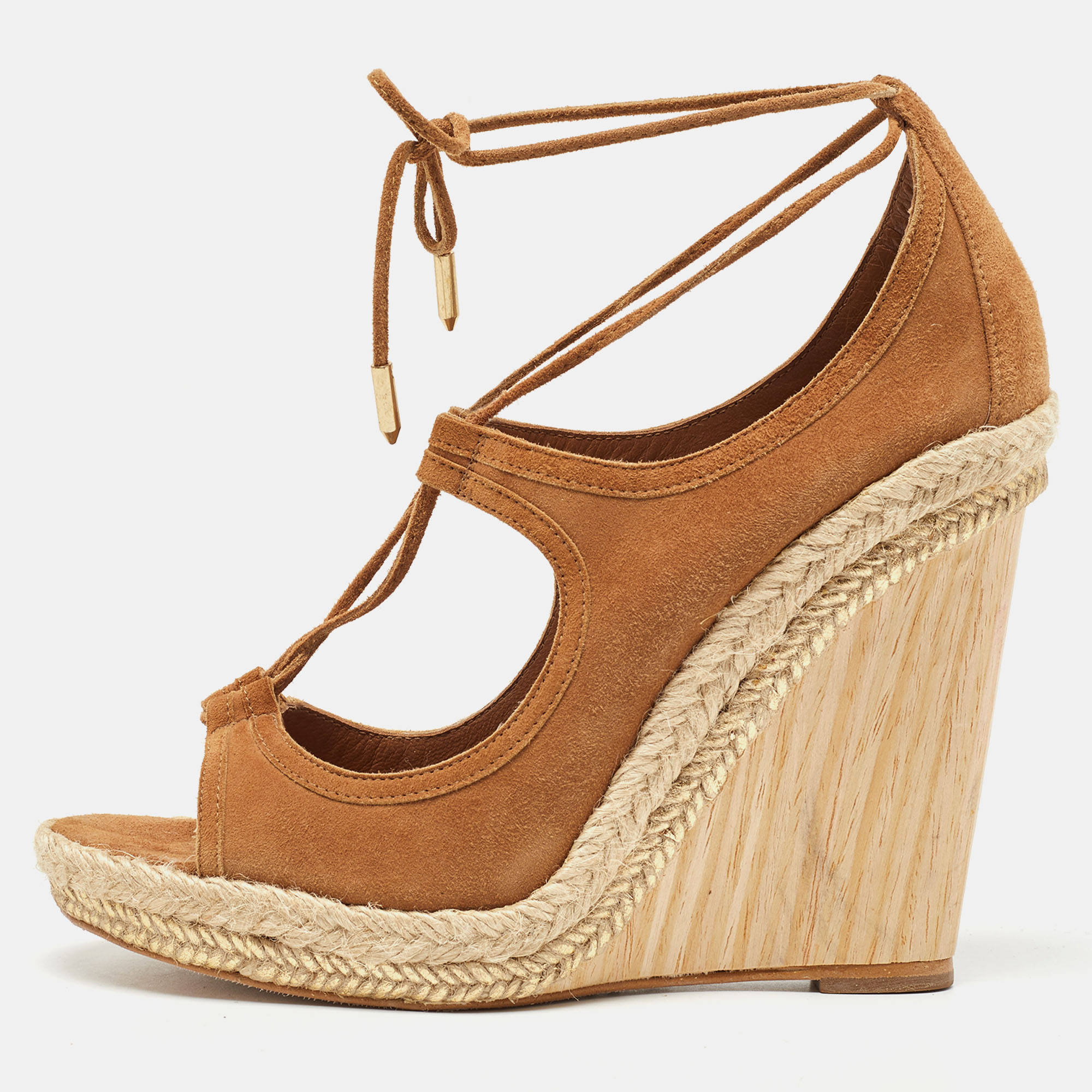 A perfect everyday wear shoe that is effortlessly stylish and easy to wear these Aquazzura Sexy Thing wedge sandals will look great with both casual and dressy looks. Constructed in brown suede material these shoes feature cutout details through the front and side and a lace tie up around the ankles to secure them in place.