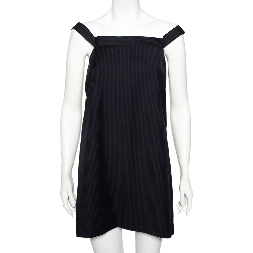 Make a style statement whenever you go out in this flattering Balenciaga dress. Look bold and elegant in this navy blue dress and you are all set to look and feel like a diva. This woolen off shoulder shift dress will lend a delicate feel to your ensemble and upgrade your style quotient immediately.