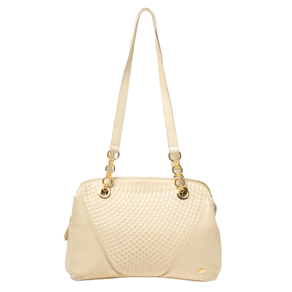 Elegance meets luxury in this bag from the House of Bally. It is created using cream quilted leather highlighted with fringe detailing. It has a leather lined interior gold tone hardware and a shoulder chain. This bag will elevate your look immediately