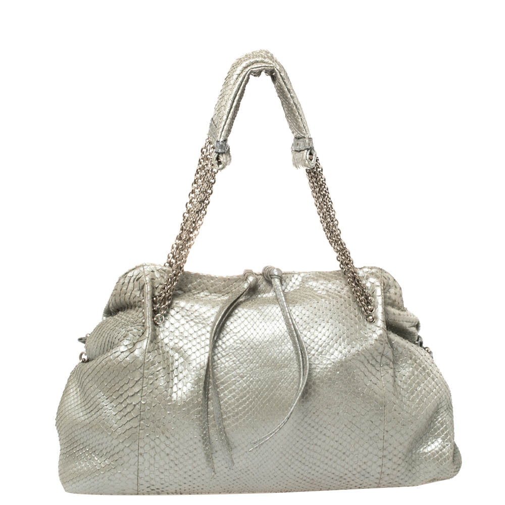 This beautiful bag from Bottega Veneta makes for a perfect everyday accessory. Crafted from python the bag features dual top handles and a suede compartment perfectly sized to carry your essentials. The exterior of the bag gloriously flaunts a silver hue. This bag artfully exudes style with a modern touch. (Available for UAE Customers Only)