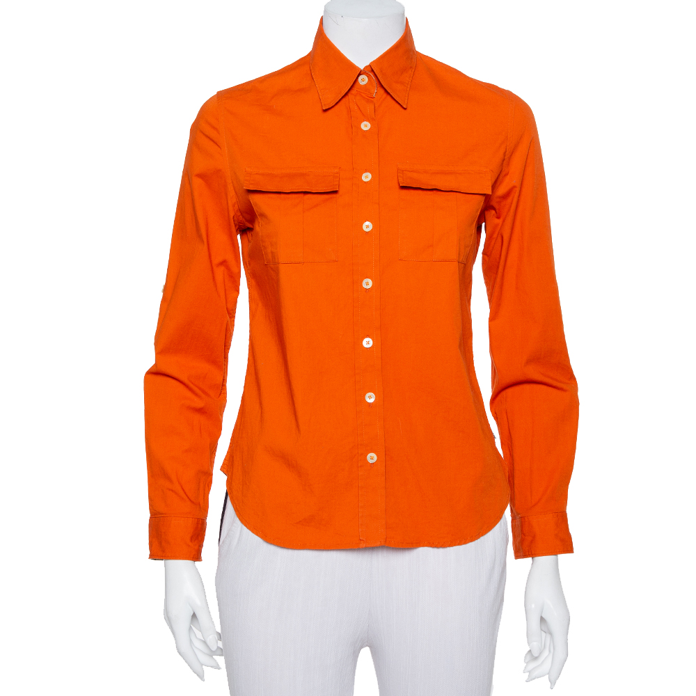 Easy to pair with both pants and skirts Burberrys orange shirt for women is tailored using a cotton blend into a smart design. It features a simple collar front button fastening front flap pockets and full sleeves.