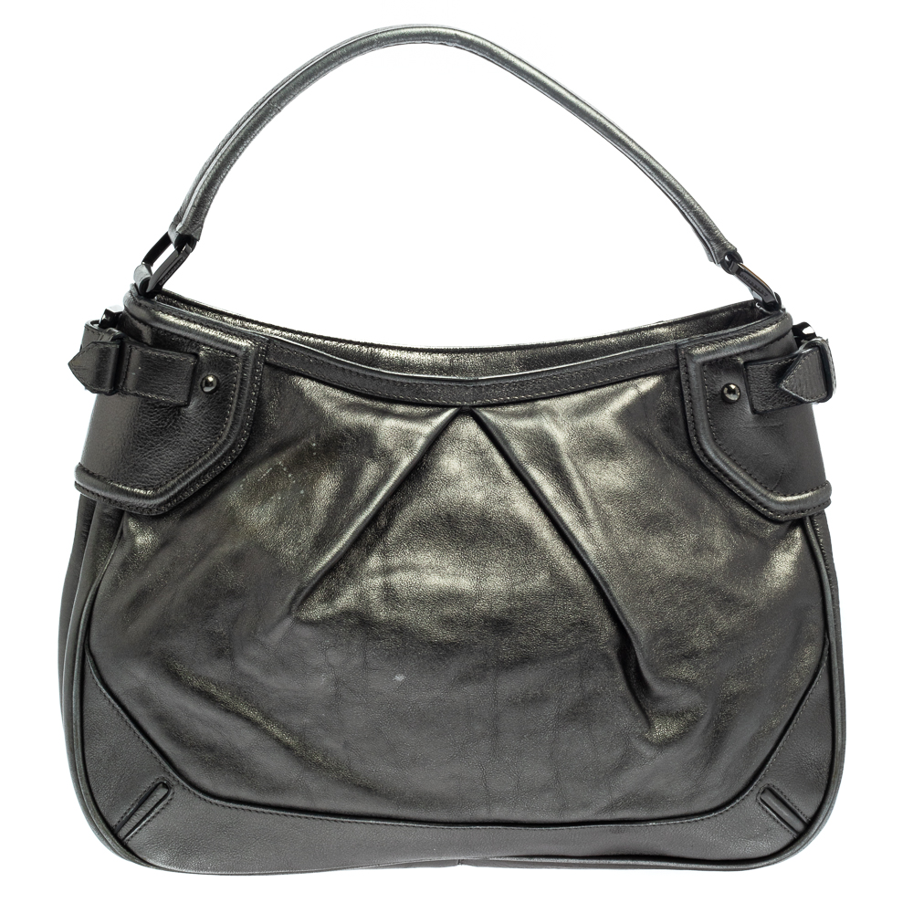 The British fashion house of Burberry originally founded in 1856 by Thomas Burberry has been renowned for its innovative and fashion forward luxury items. This Fairby hobo is a head turning everyday handbag. It is crafted from leather in a metallic hue. This elegant number features a top zip closure and a single leather handle.