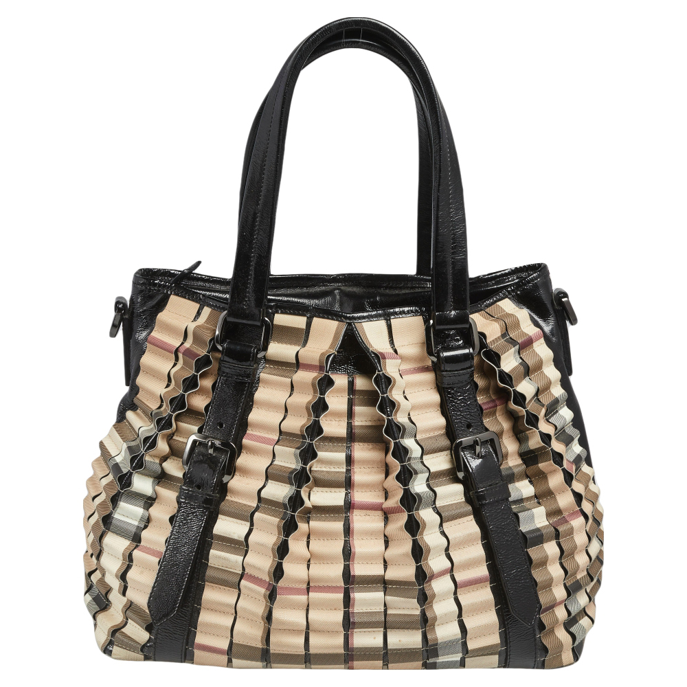 This Burberry Lowry is a harmonious fusion of excellent craftsmanship and timeless style Meticulously made from House Check PVC and patent leather the bag features a lovely ruffled exterior. The bag is equipped with protective metal feet at the bottom dual top handles and a canvas lined interior that will hold all your belongings. It is high in both appeal and design.