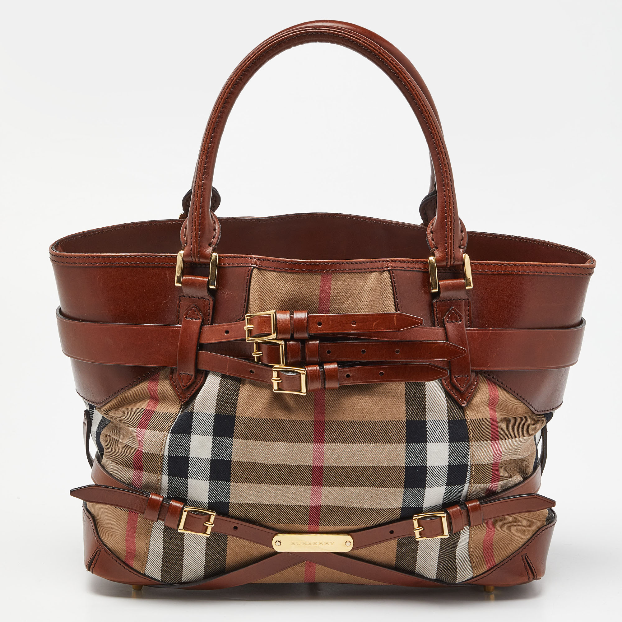 Walk out the door with the Burberry tote on your arm. Fashioned in House Check fabric and leather the tote has two short handles and a spacious interior.