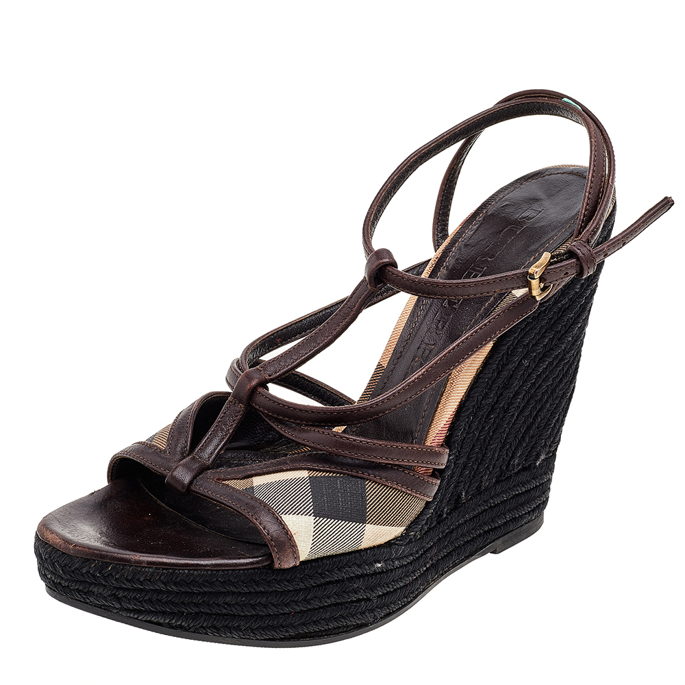 These Burberry sandals are a reflection of the labels immaculate artistry in shoemaking. Crafted from canvas and leather in a brown shade these beauties have a timeless appeal and feature crisscrossed straps and wedge heels supported by platforms.