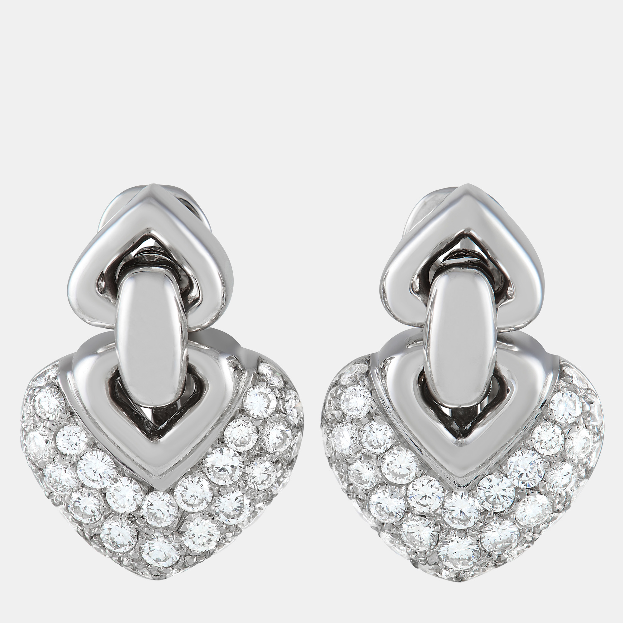 These Bvlgari Doppio Cuore earrings feature a dangling heartshaped motif covered in pavx E9 diamonds totaling 2.25 carats. Stylish and sophisticated in design they crafted from 18K White Gold for a touch of extra shimmer. Each one measures 1.0 long and 0.65 wide.