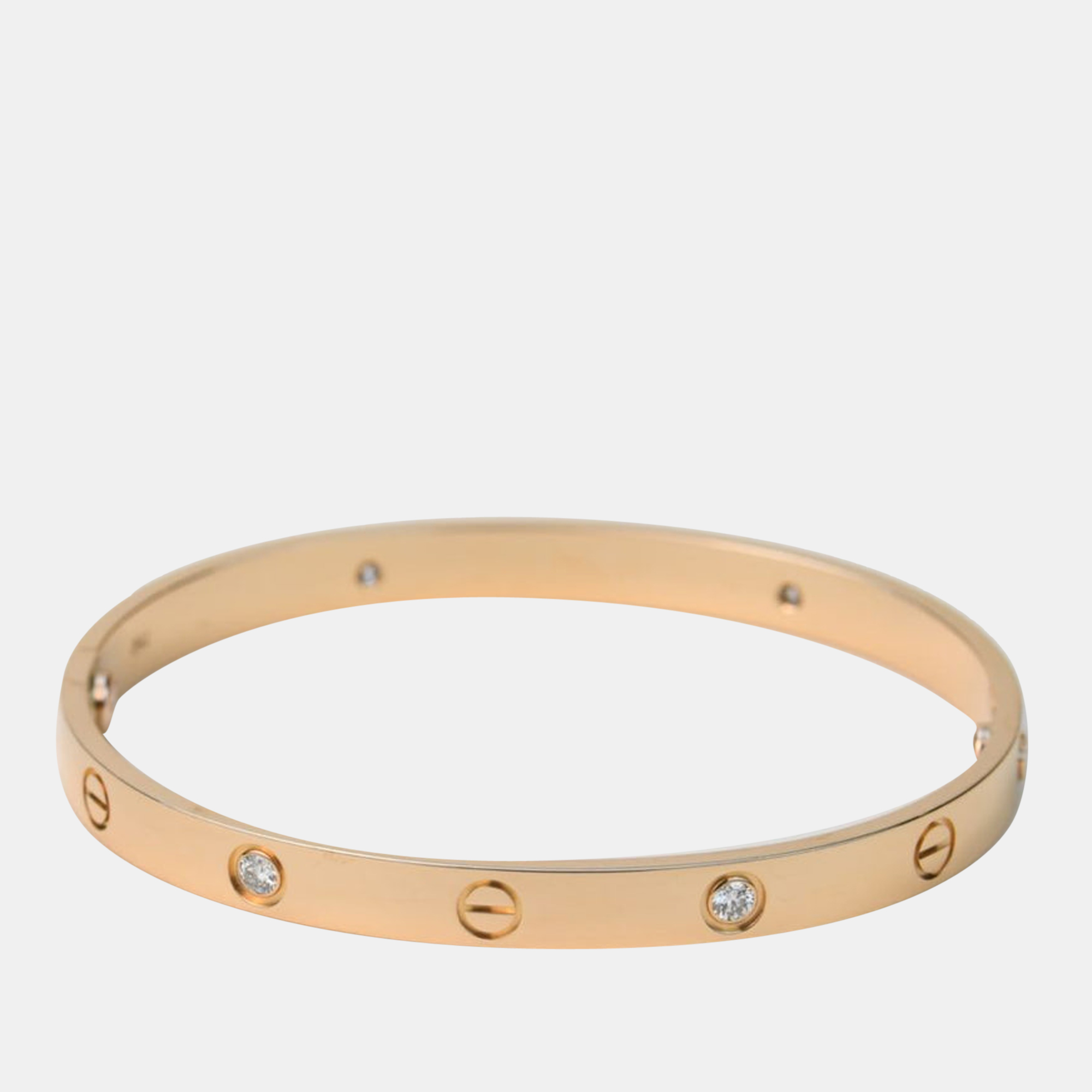Cartiers Love bracelet is a modern symbol of luxury and a way to lock in ones love. Designed in an oval shape to comfortably sit around your wrist this iconic love handcuff is laid with distinct screw motifs and diamonds.