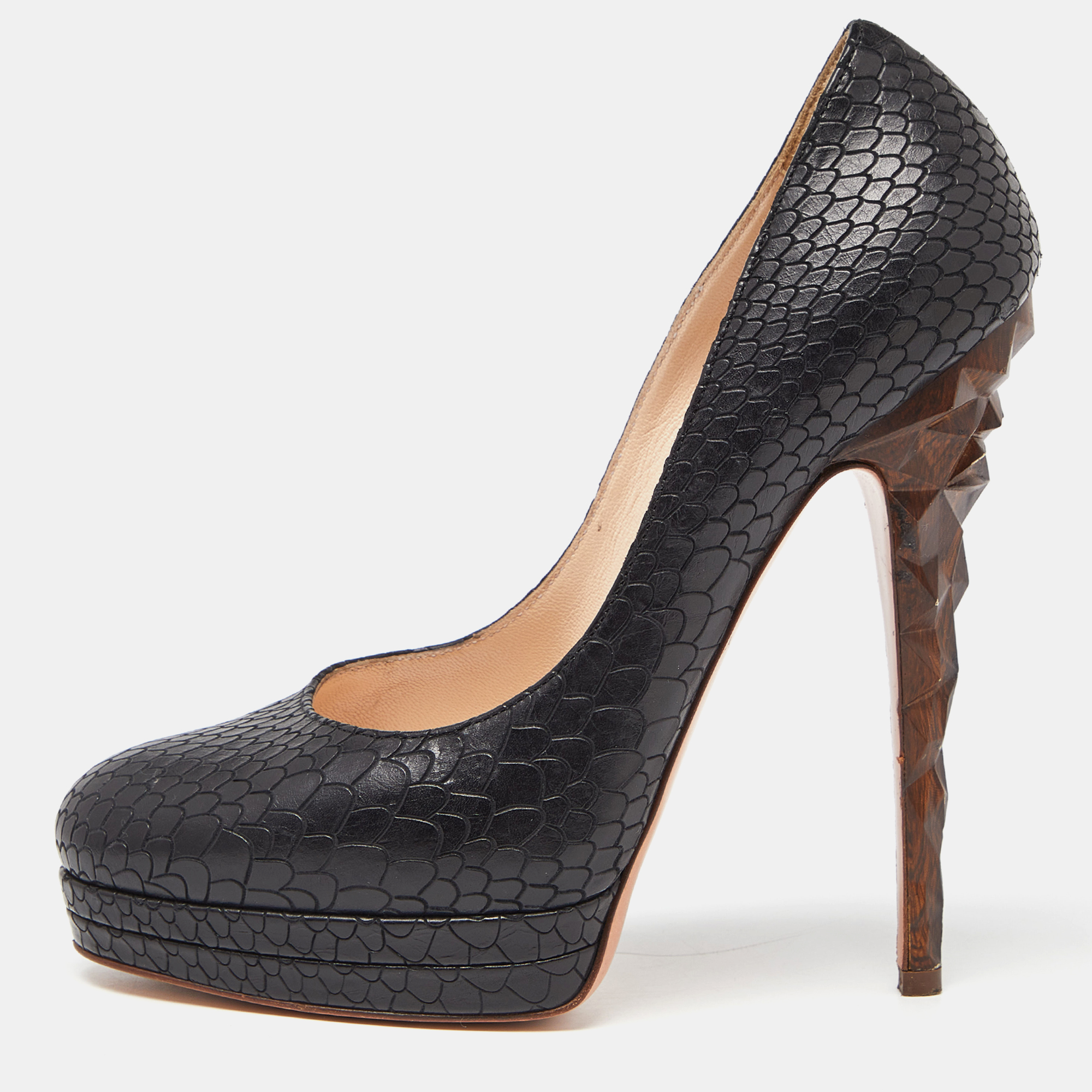 Make the streets your fashion runway with these spectacular pumps from Casadei. Chic in black these pumps are crafted from python embossed leather exterior. They flaunt solid platforms sculpted high heels and comfortable leather lined insoles.