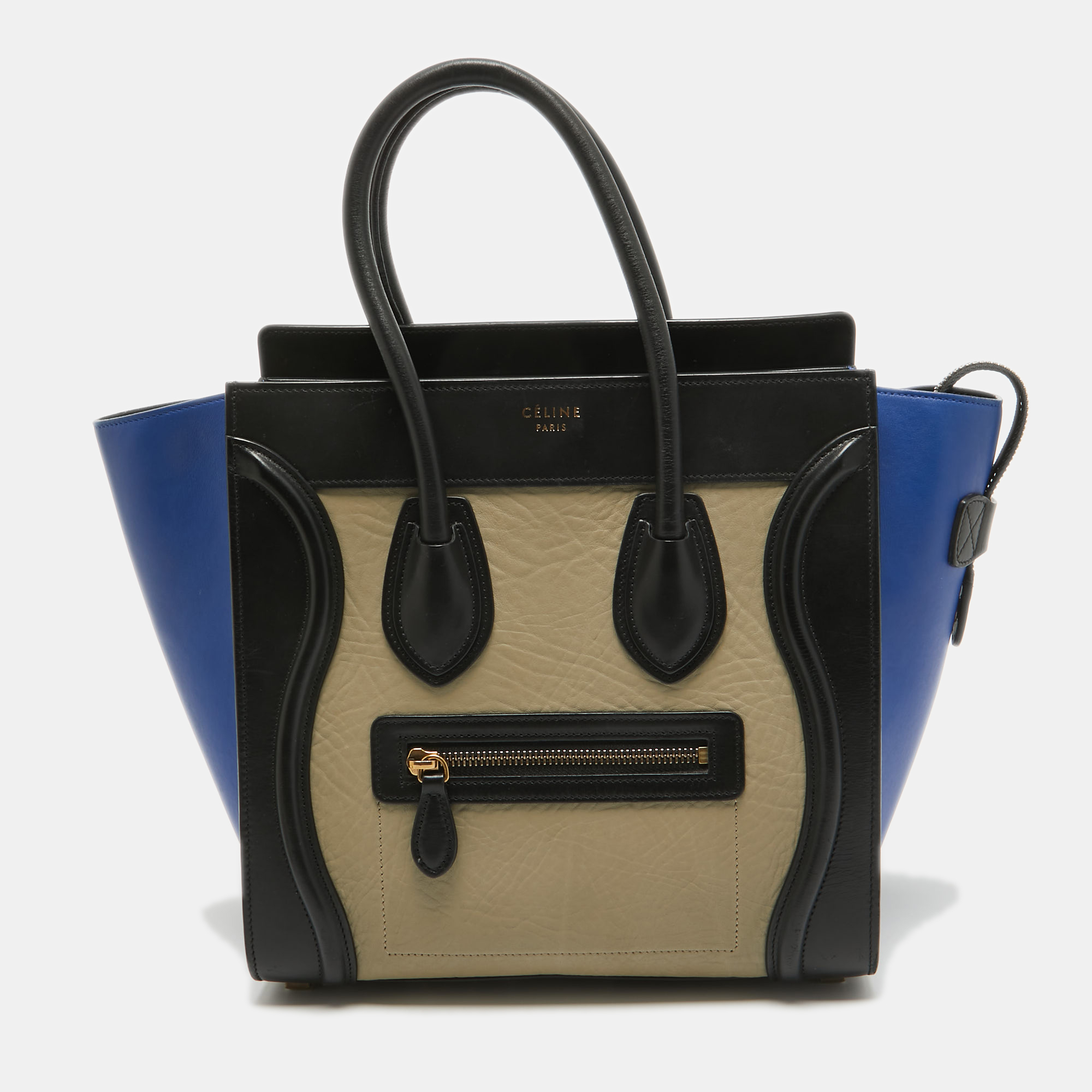 The usage of tricolor leather on the exterior gives this Celine tote a high appeal. An eye catching accessory the bag features a front zipper pocket dual handles at the top and gold tone hardware. The lined interior is equipped to store more than just your phone and tiny essentials. The flappy wings at the sides and the brand signature on the front complete this design.