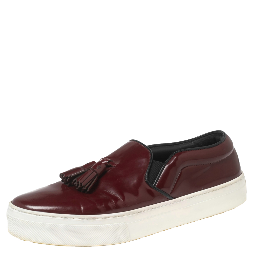 Exude charm and sophistication as you walk in these sneakers from the House of Celine. They are designed using burgundy leather with tassel motifs placed on their vamps. They feature an easy slip on style. Complement these stunning Celine sneakers with your casual outfit and look classy