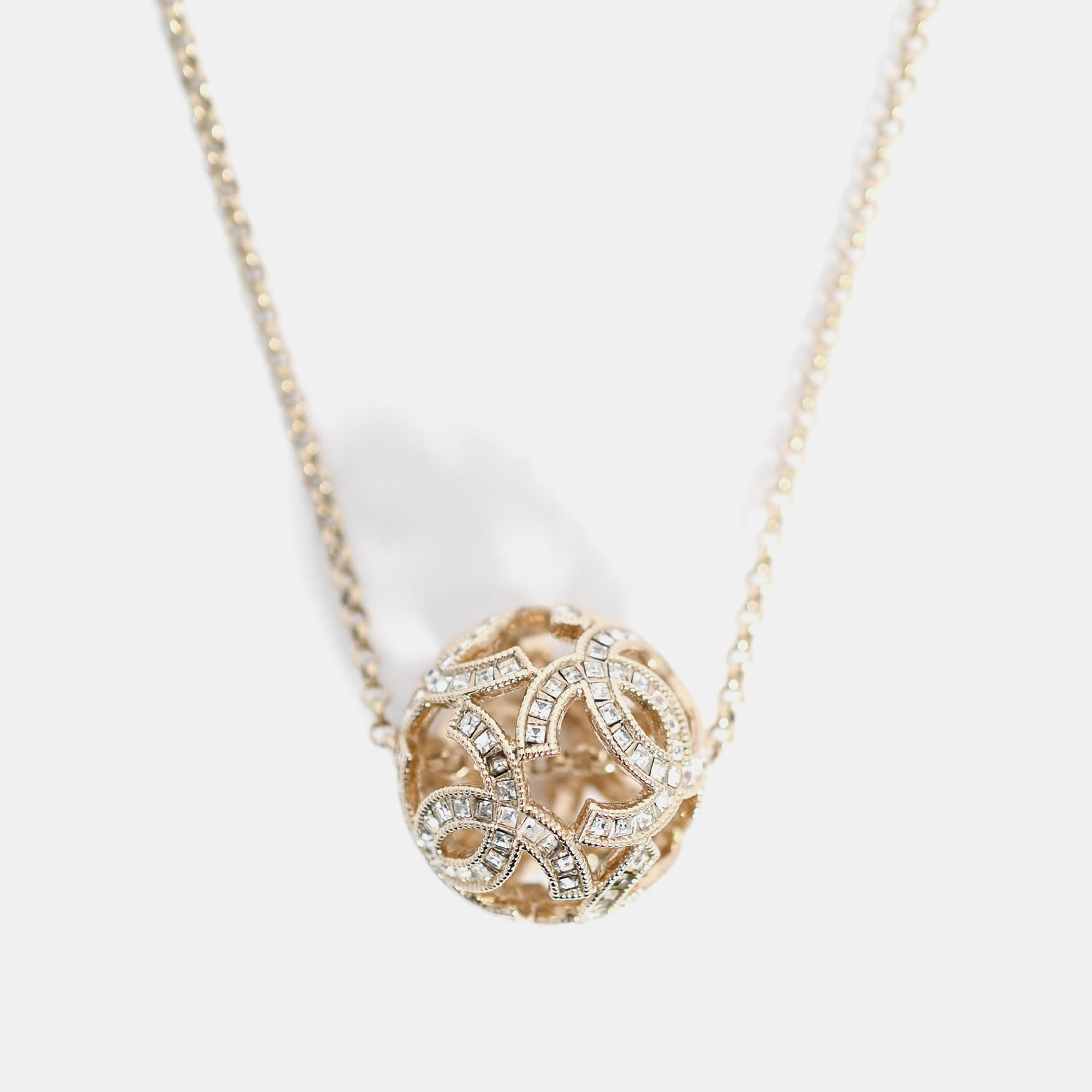 

Chanel Gold Tone Baguette Crystal CC Ball Pendant Necklace