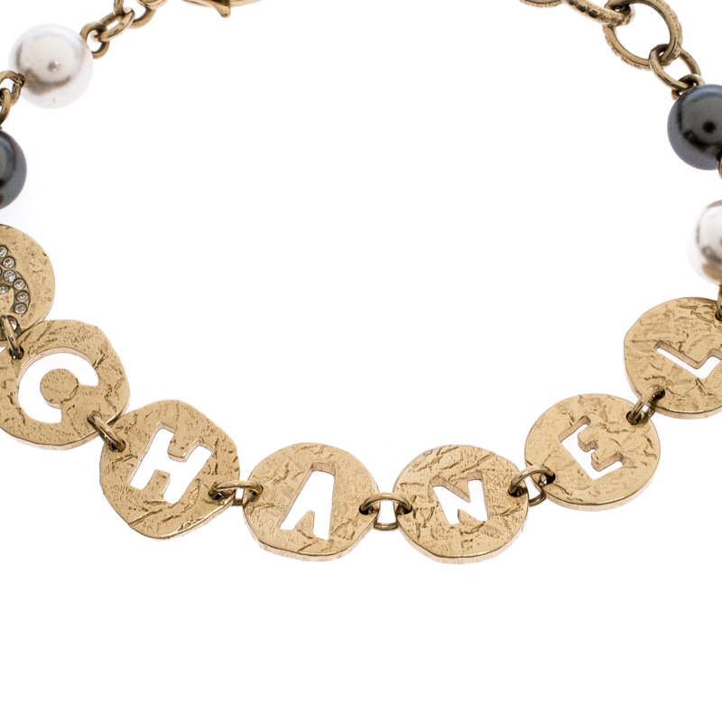 

Chanel Aged Gold Tone Cutwork Logo Charm Beaded Bracelet