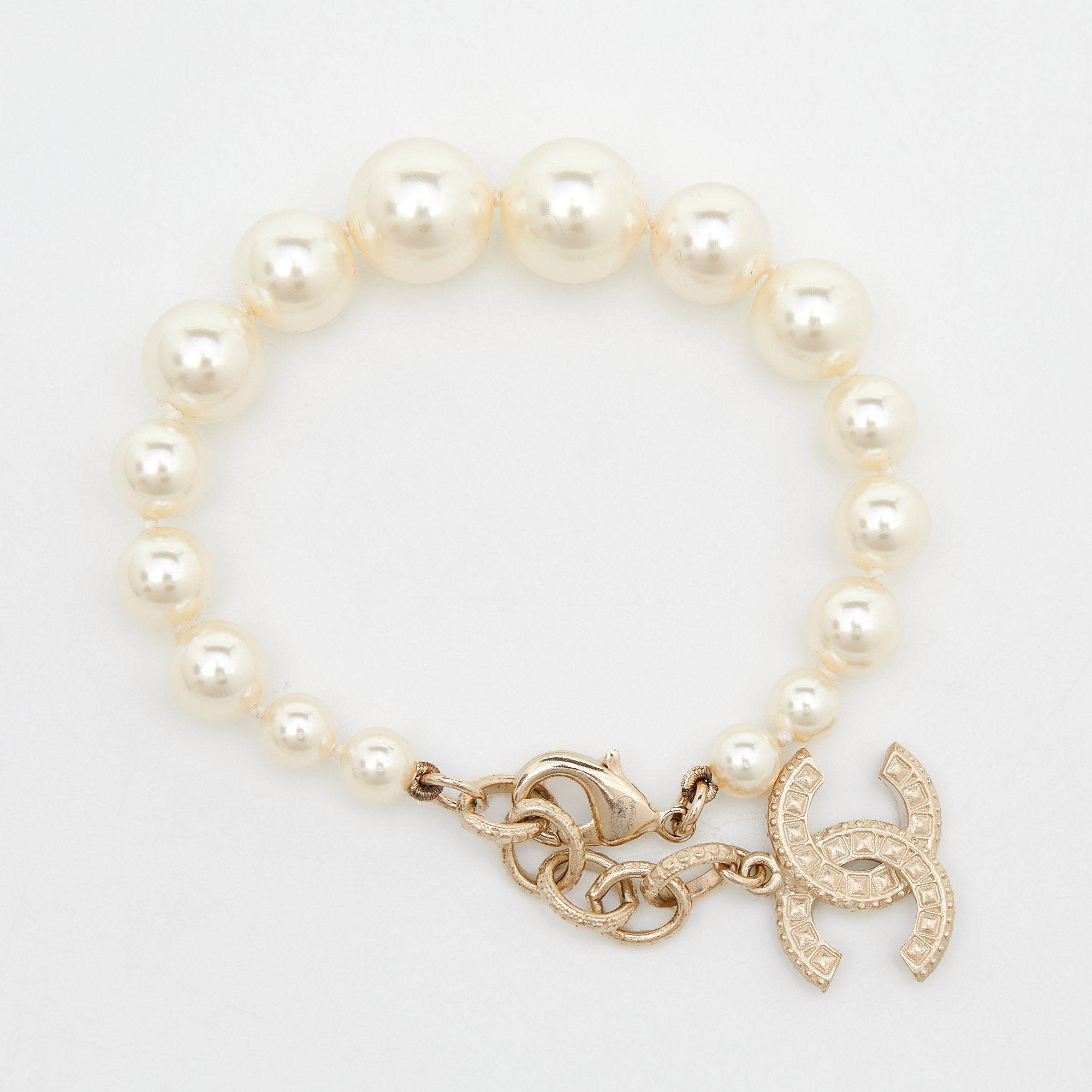 

Chanel Gold Tone Faux Pearl Crystal CC Charm Bracelet