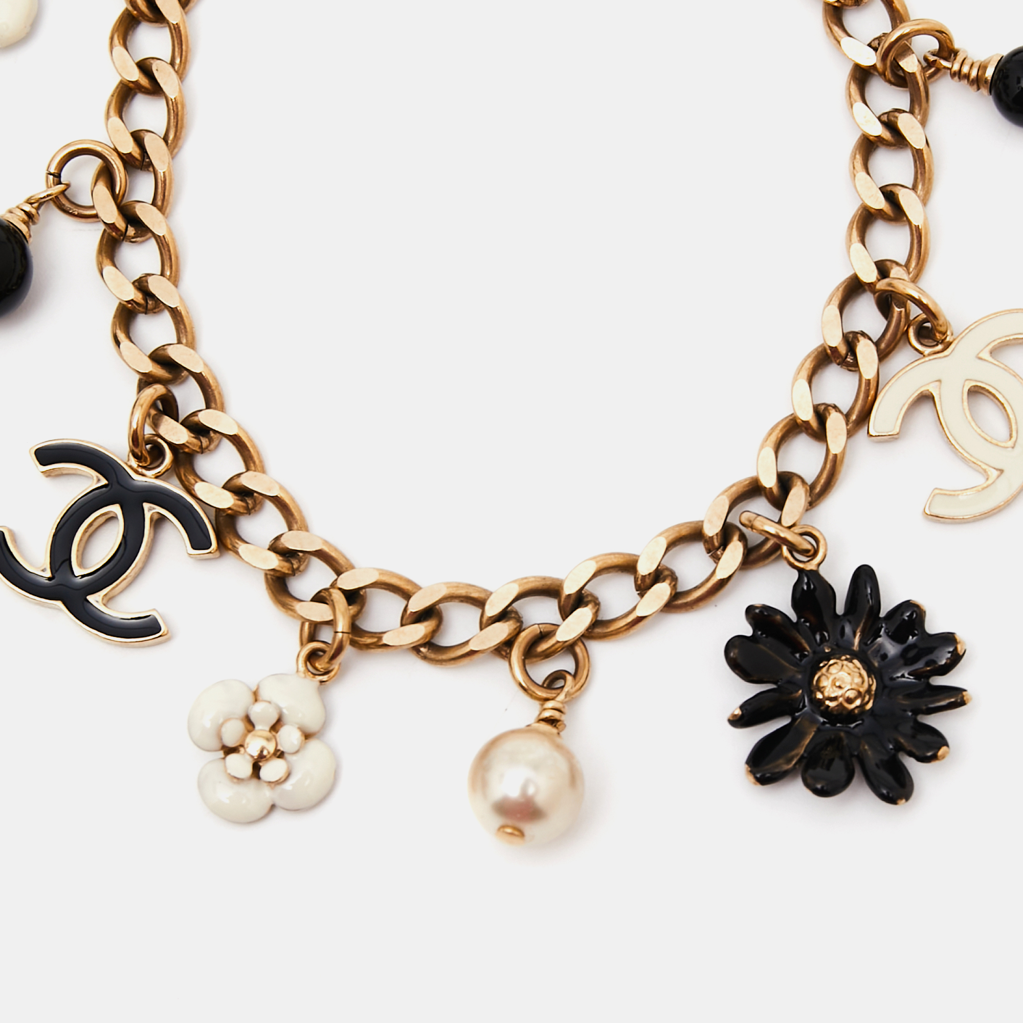 

Chanel Gold Tone Daisy & Camelia Enamel Charms Bracelet