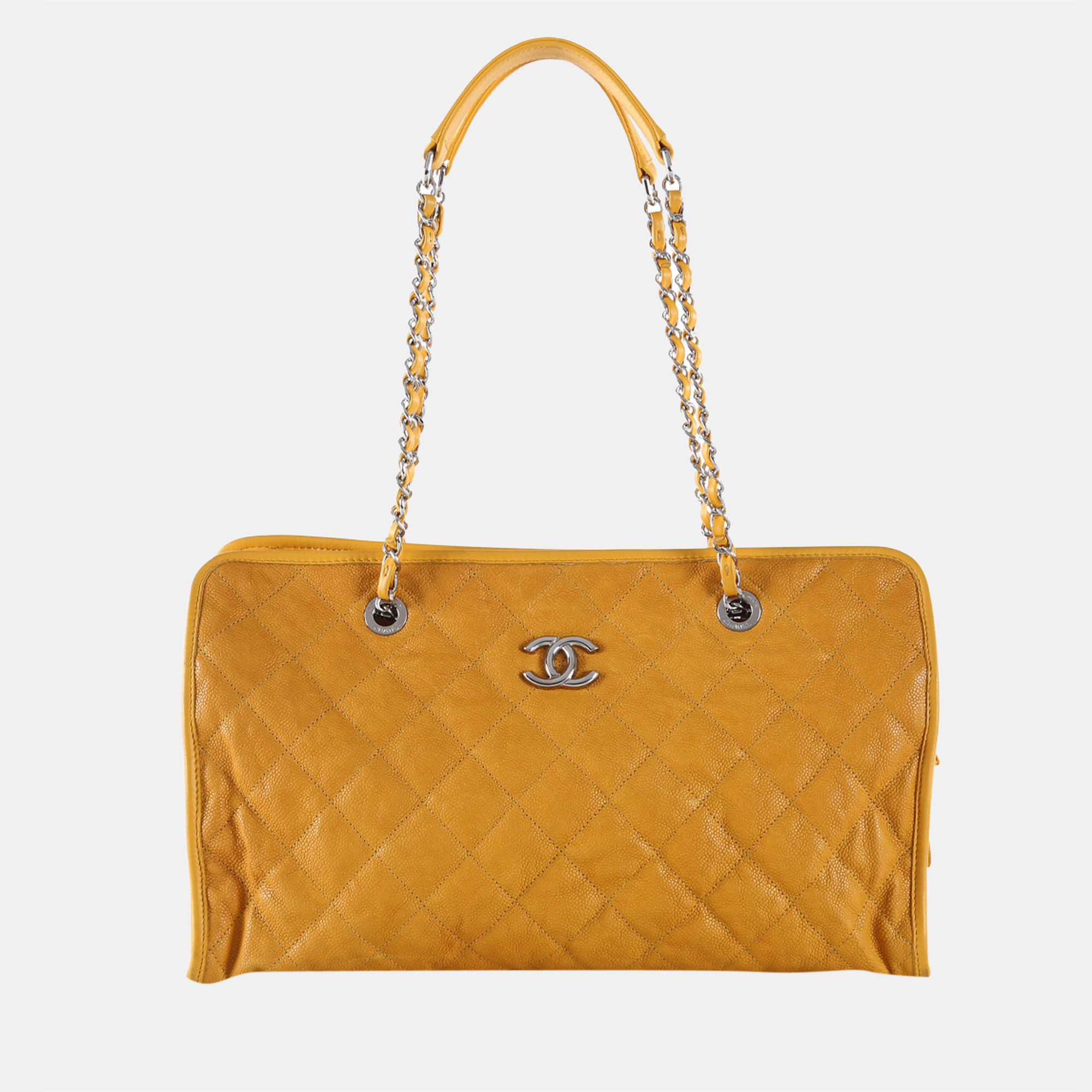 This Chanel bag is crafted from yellow caviar leather with quilted stitching. It features double leather and chain shoulder straps with leather shoulder pads CC metal logo at the front top magnetic snap button which opens to a large burgundy canvas lined interior compartment with a zip and two patch pockets a middle zipped compartment four protective base studs and silver tone hardware.