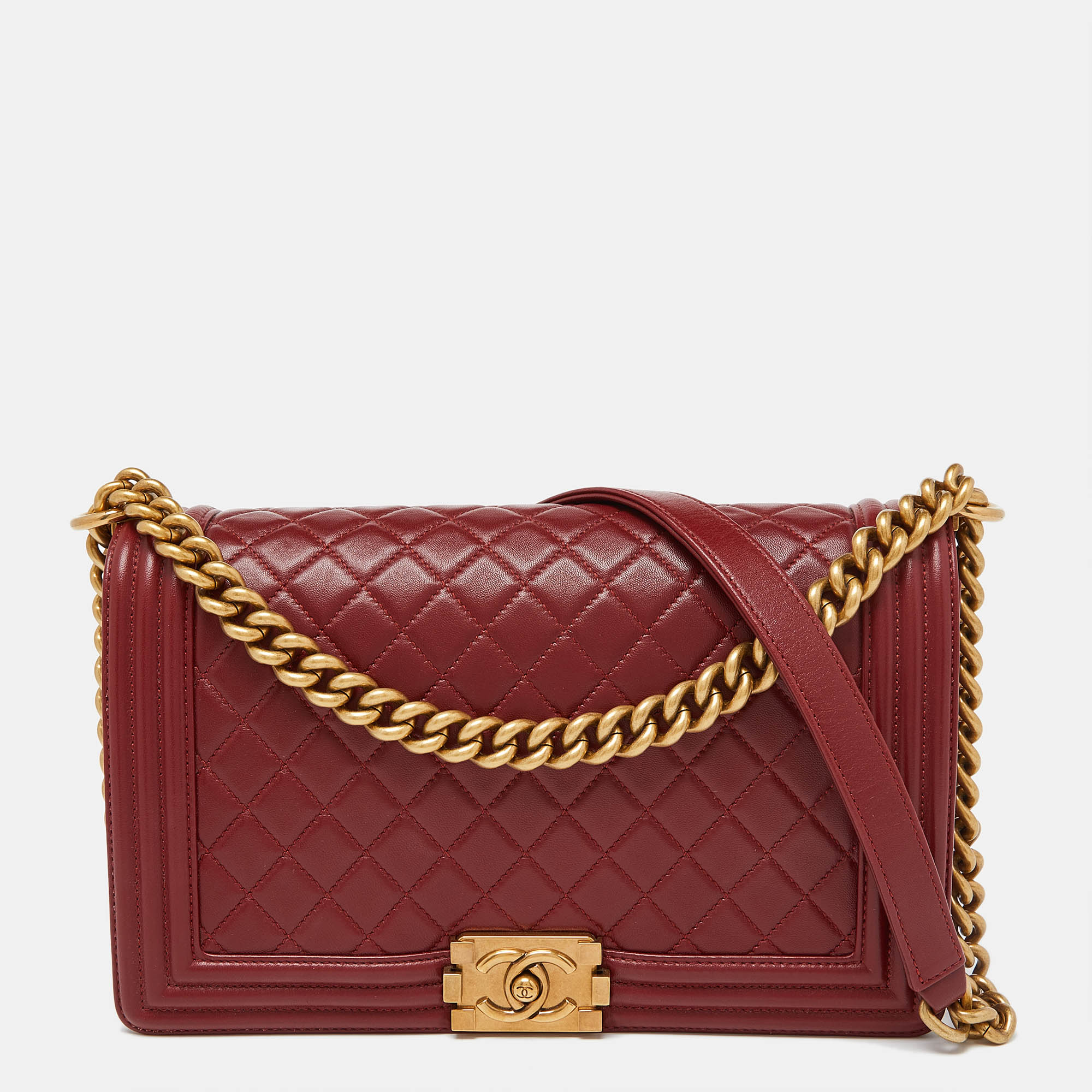 This stylish Boy flap bag from Chanel has been crafted from red leather. It opens to a capacious interior that can easily hold your everyday essentials. The bag is finished with gold tone hardware.