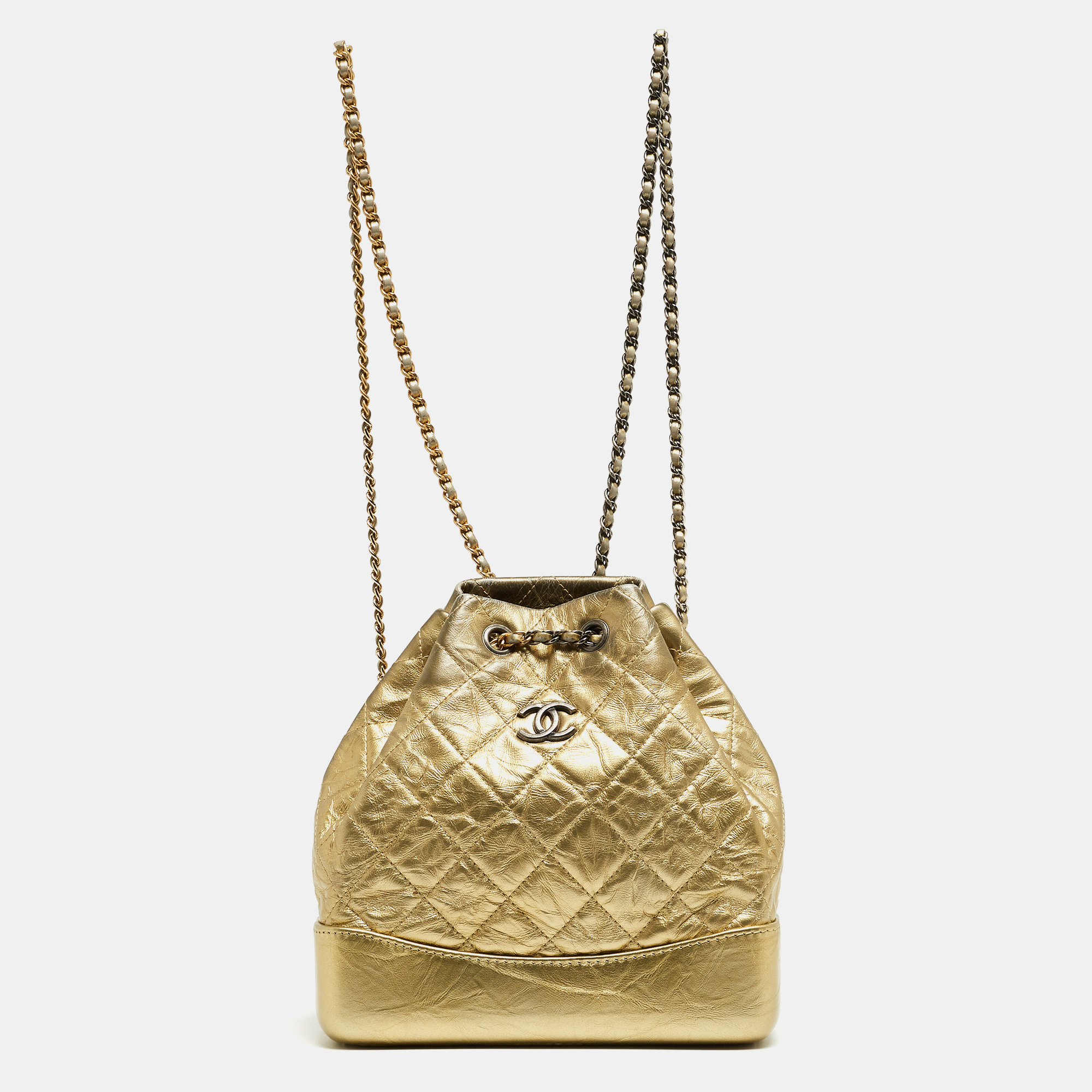 This Gabrielle backpack by Chanel boasts fabulous style and luxe details. It flaunts a gold leather exterior with a CC logo on the front and quilt detailing all over. The bag has a chain link which acts as shoulder straps and also secures the fabric interior. This gorgeous piece will bring you countless days of high style.