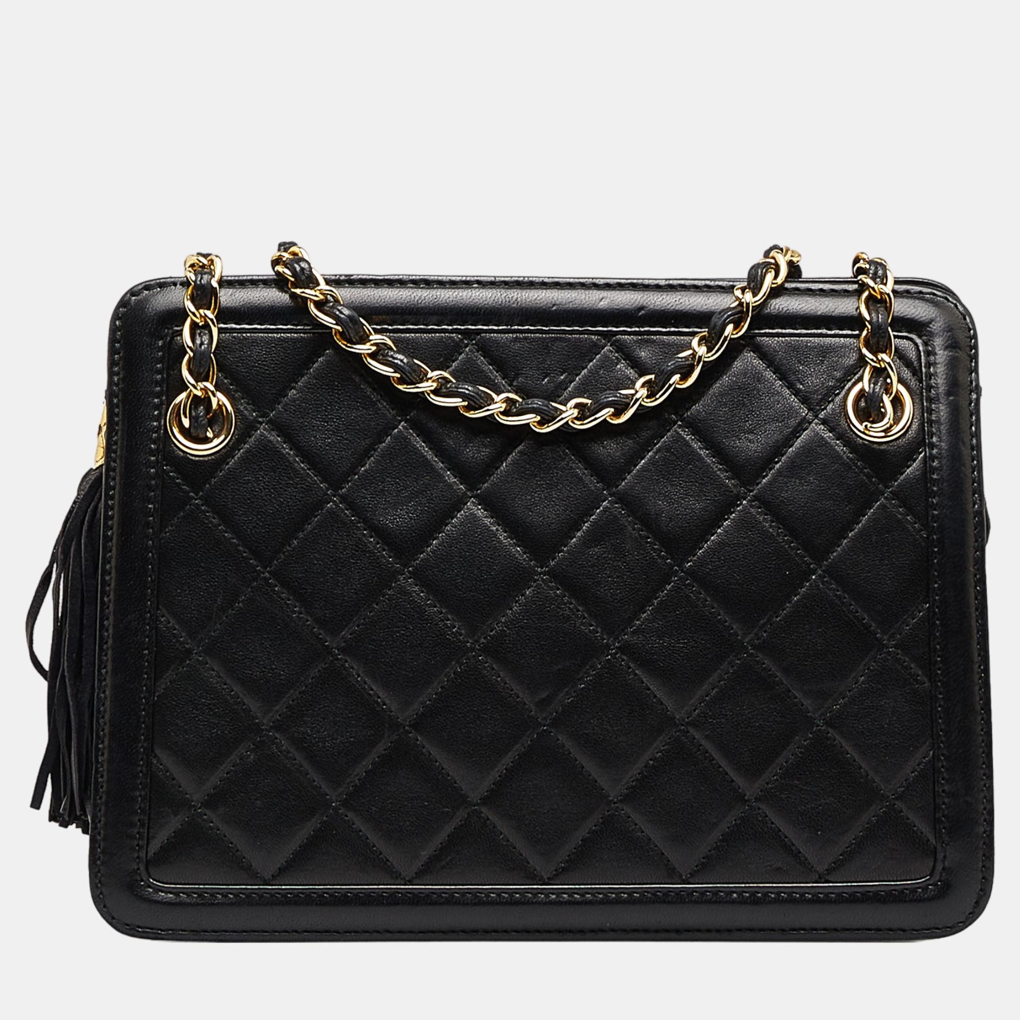This shoulder bag features a quilted lambskin leather body with tassel detail leather woven chain straps a top zip closure and interior zip and slip pockets.