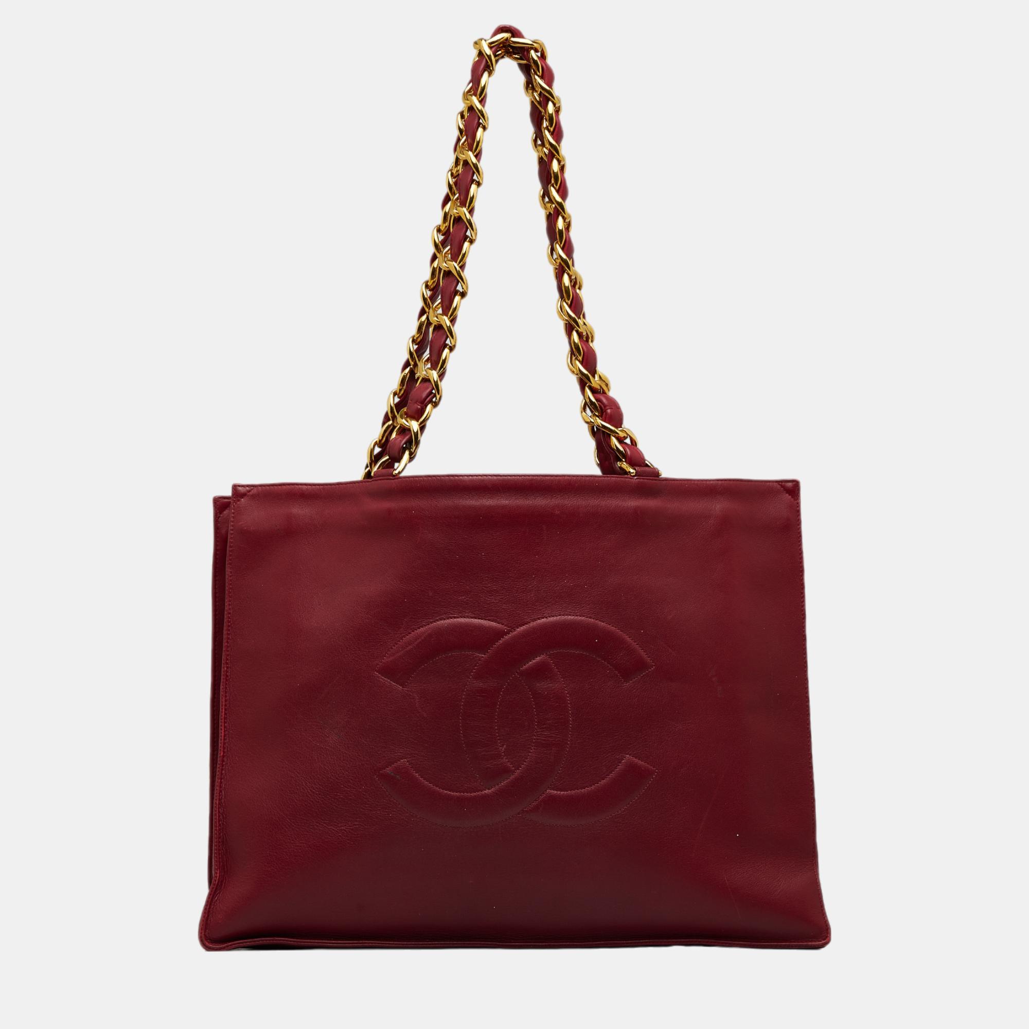 This tote bag features a lambskin leather body leather woven chain shoulder straps an open top and an interior zip pocket.