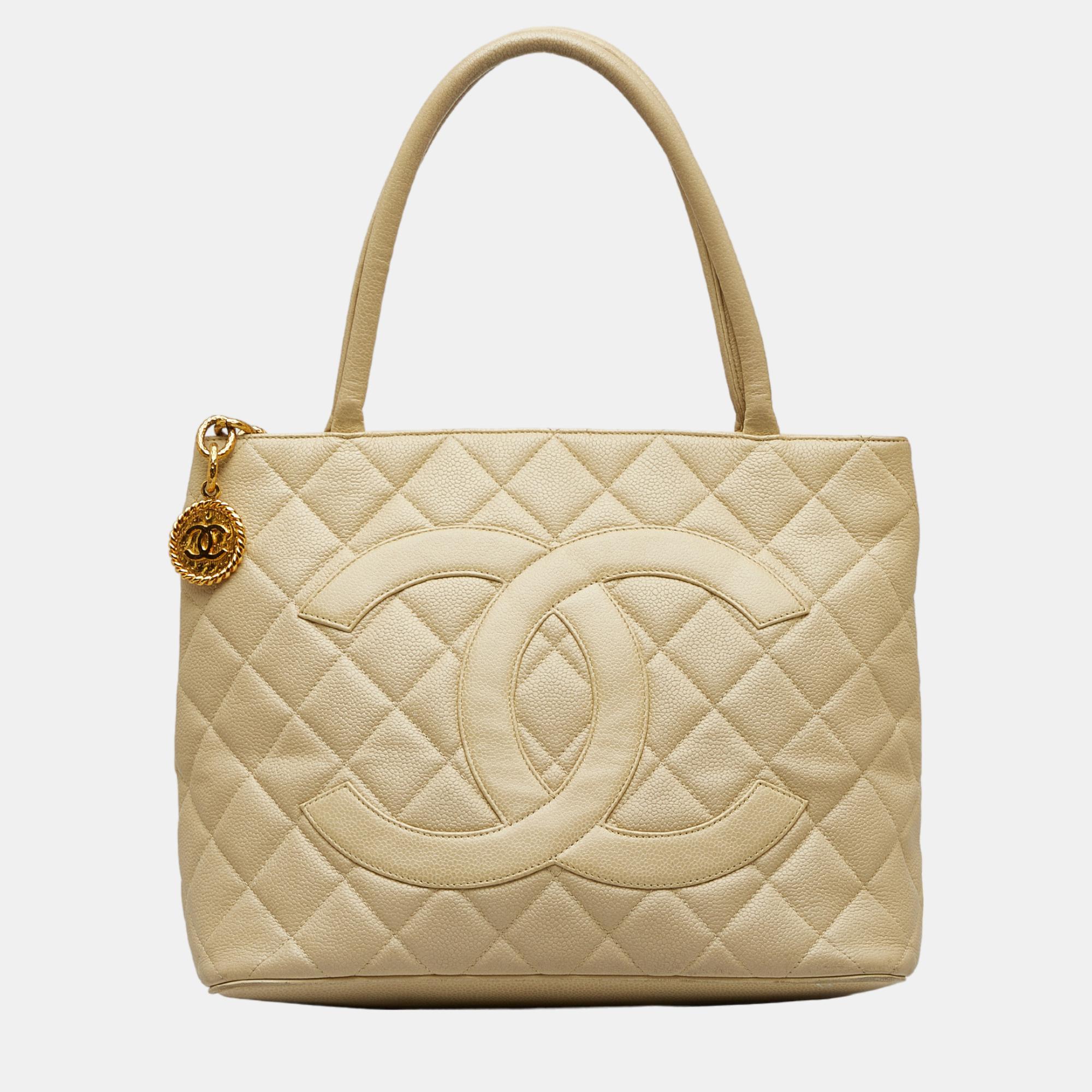 The Medallion tote bag features a quilted caviar leather body rolled leather handles a top zip closure an exterior back slip pocket and interior zip and slip pockets.
