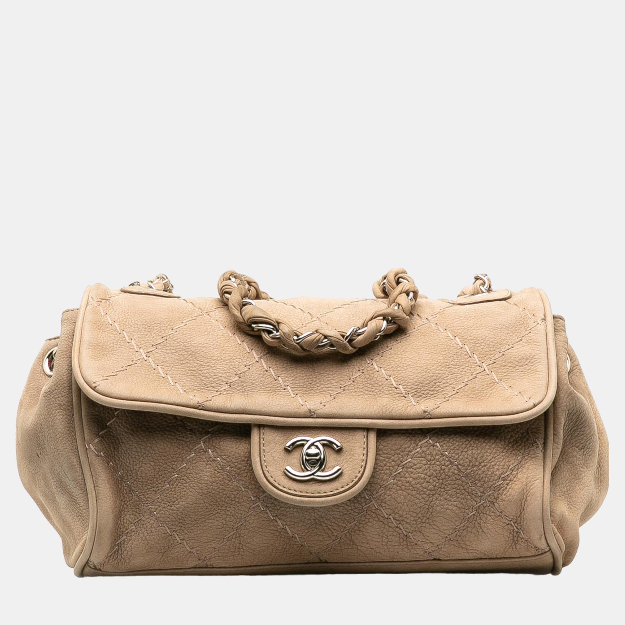 This shoulder bag features a leather body leather woven chain straps a front flap with CC twist lock closure an exterior slip pocket and interior zip and slip pockets.