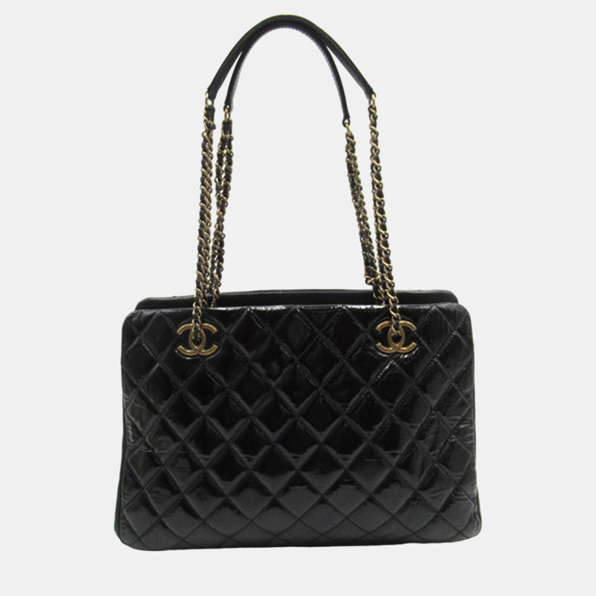 This shoulder bag features a quilted patent goatskin leather body a leather woven chain shoulder strap with leather guard a top zip closure interior open compartments and an interior zip pocket.