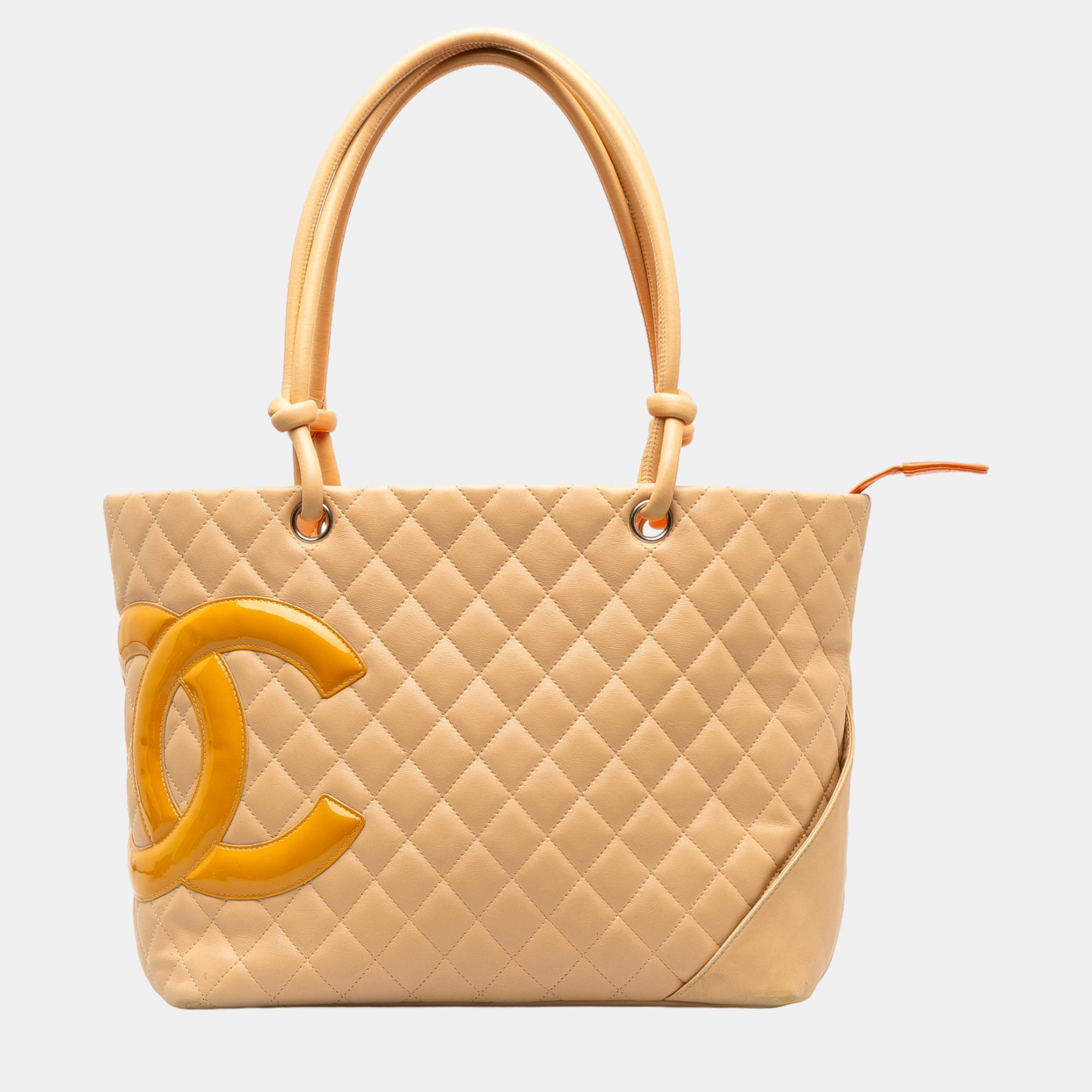 The Cambon Ligne tote features a quilted lambskin leather body rolled leather handles a top zip closure an exterior back slip pocket and an interior zip pocket.