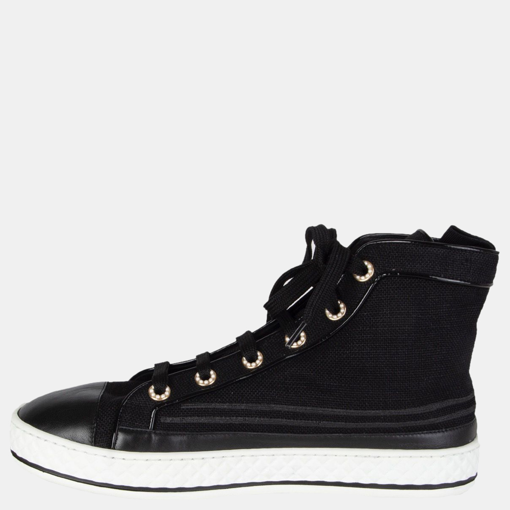 Chanel presents this glamorous pair of sneakers for the fun and trendy professional. It has a mid top style with a closed toe design and a black exterior with white rubber soles and black laces. It can be worn with denim jeans and a polo t shirt. Inside Sole: 26 cm (10.1 in) Width: 8 cm (3.1 in)