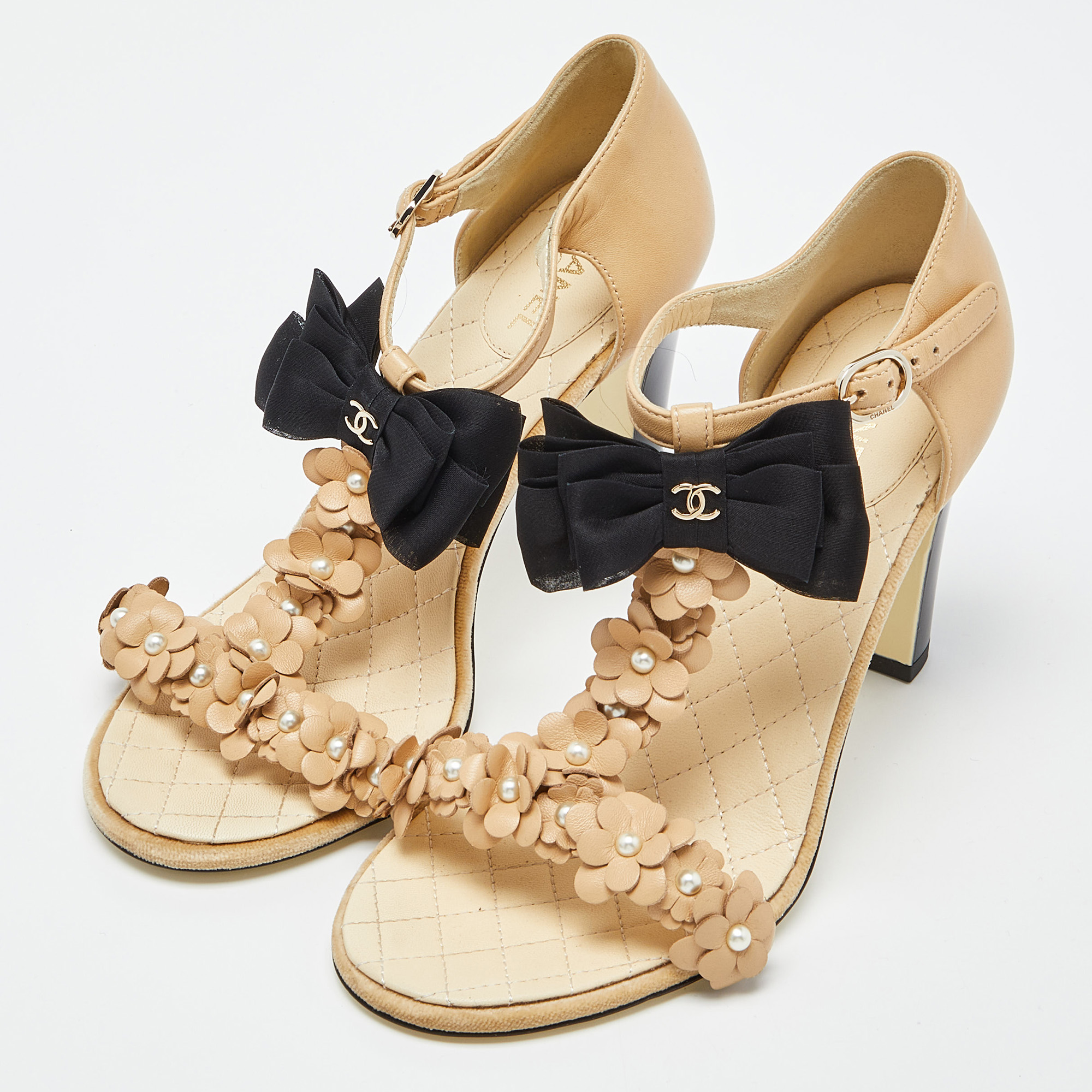 

Chanel Beige/Black Leather Faux Pearl Embellished Camellia and CC Bow T-Strap Sandals Size