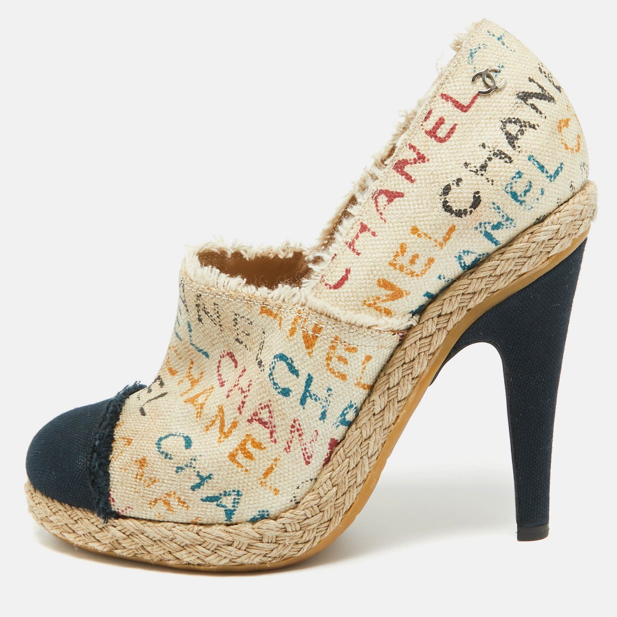 Deliver a signature look with these Chanel espadrille pumps. Crafted meticulously from canvas with chic graffiti detailing on the upper they come in a lovely shade of beige that is contrasted with navy blue cap toes. They are styled with low platforms 11cm heels and rubber soles.